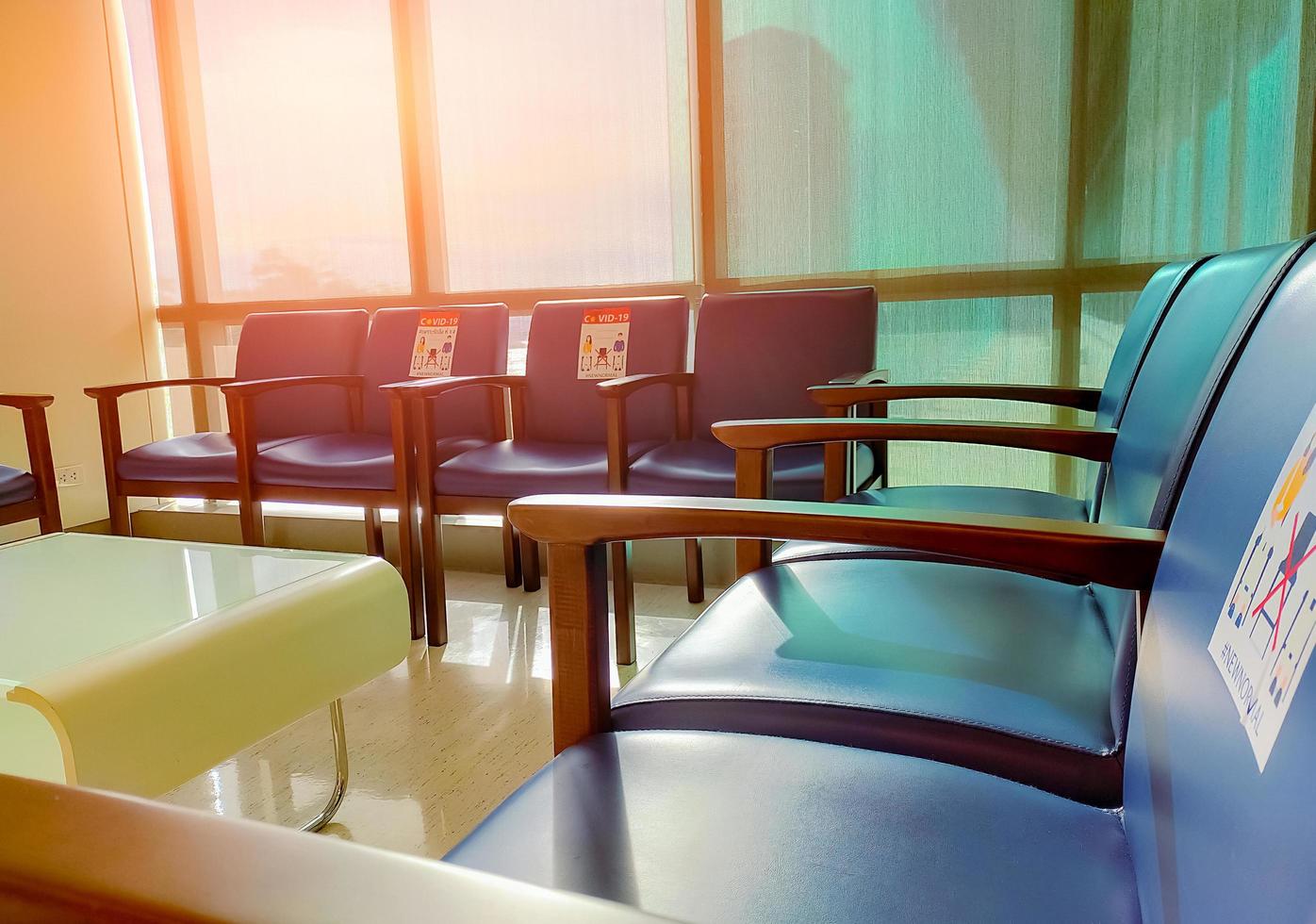 Social distancing. Empty dark blue chair with gap for social distance to prevent coronavirus COVID-19 at waiting room in office for waiting queue. Public chair for social distancing in new normal. photo