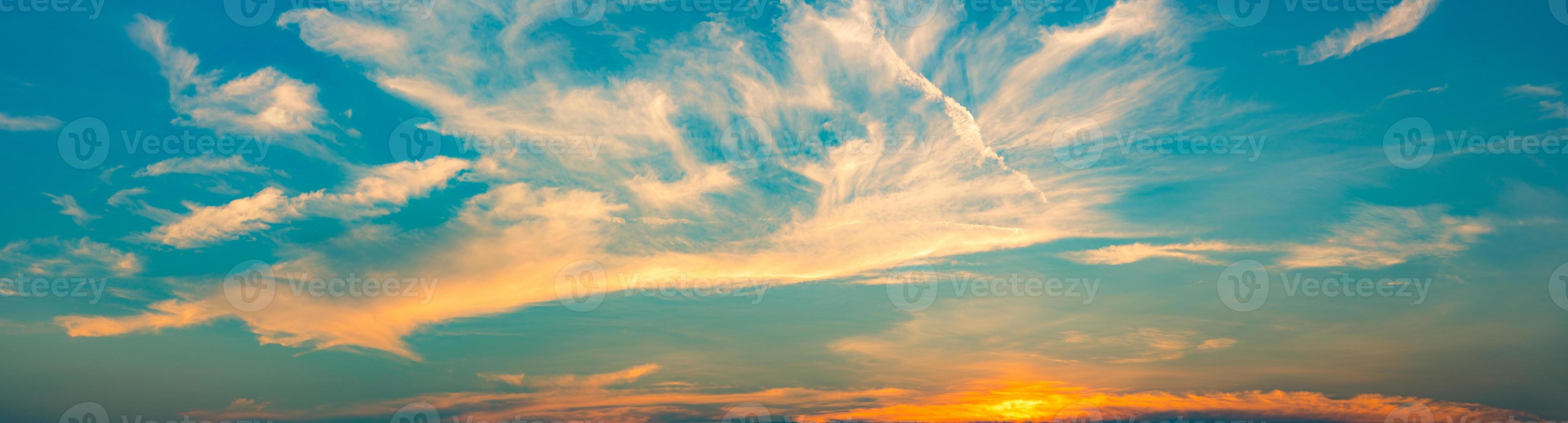 Beautiful blue and golden sky and clouds abstract background. White and golden clouds on sunset sky. Warm weather background. Art picture of sky at sunset. Sunset and fluffy clouds for inspiration. photo