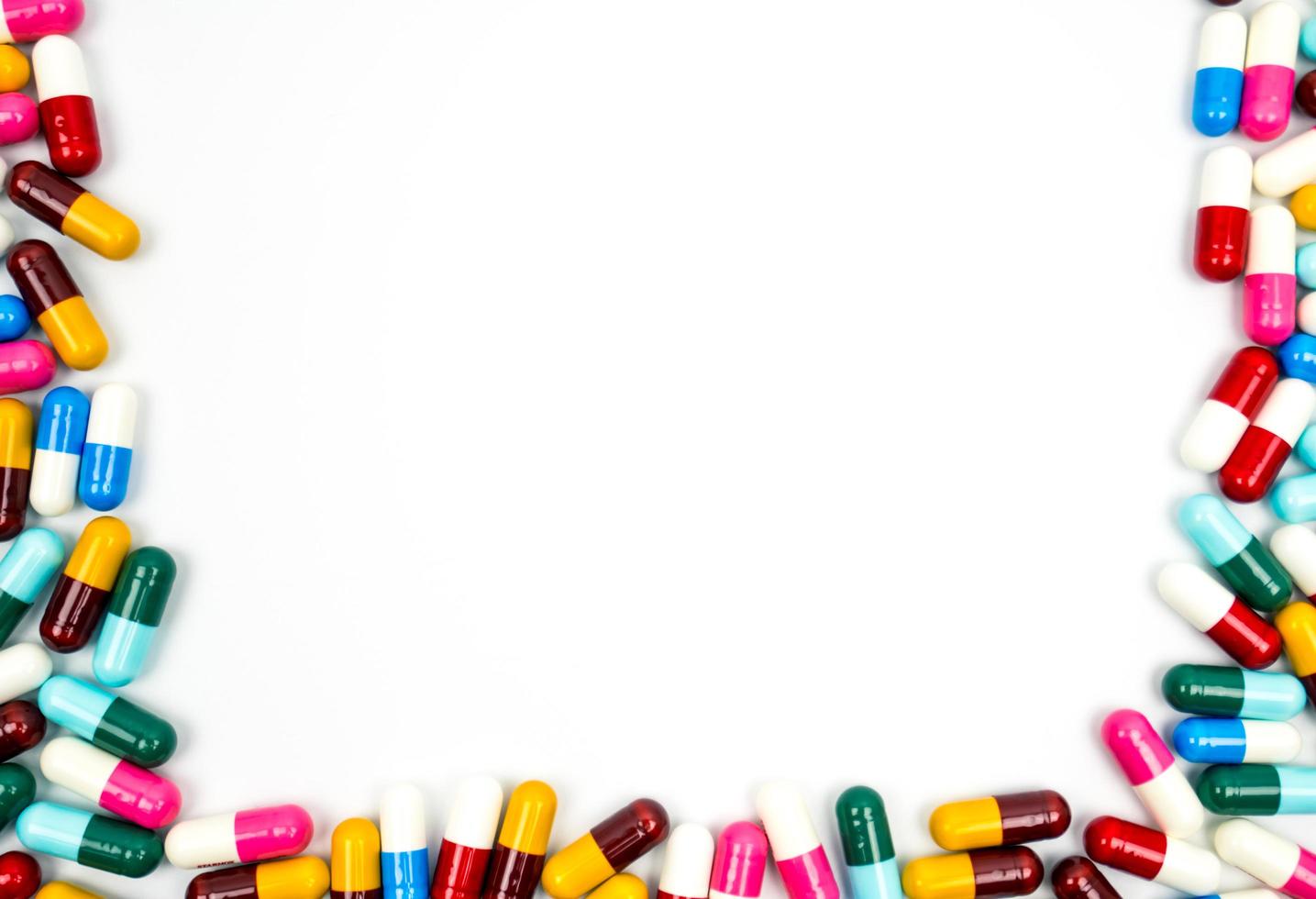 Colorful of antibiotic capsules pills frame isolated on white background with copy space. Drug resistance concept. Antibiotics drug use with reasonable and global healthcare concept. photo