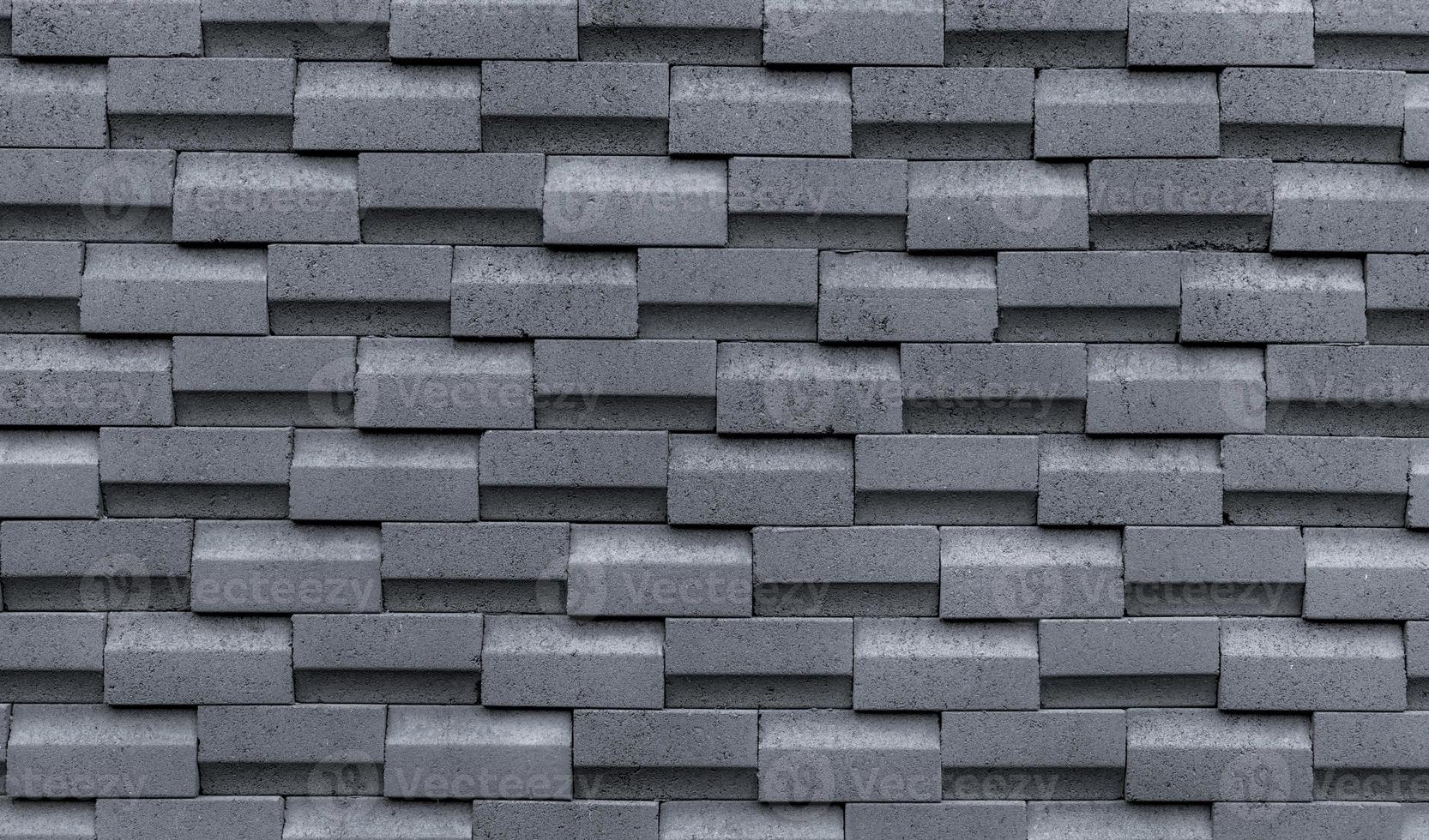 Gray brick wall with simple pattern. Gray wall texture abstract background. Modern design of brick wall background. Simple abstract wallpaper. Concrete surface texture. Exterior architecture design. photo