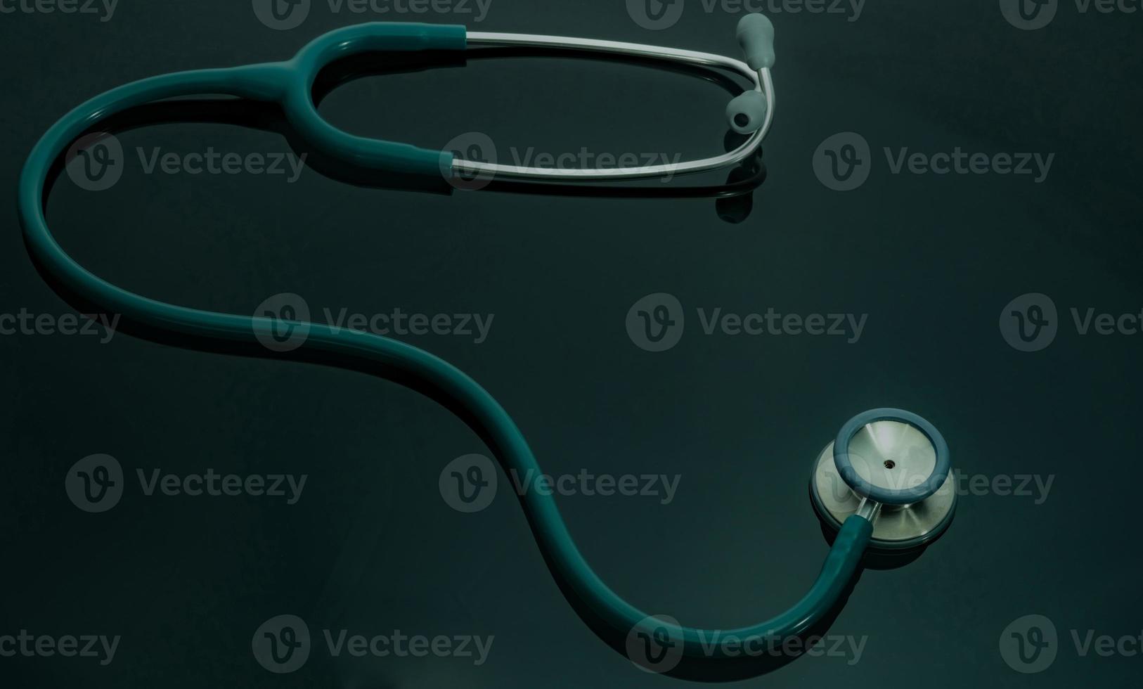 Green stethoscope on doctor table or nurse desk. Health checkup or health insurance concept. Cardiology doctor equipment. Medical healthcare background. Physician tool for patient diagnosis. photo