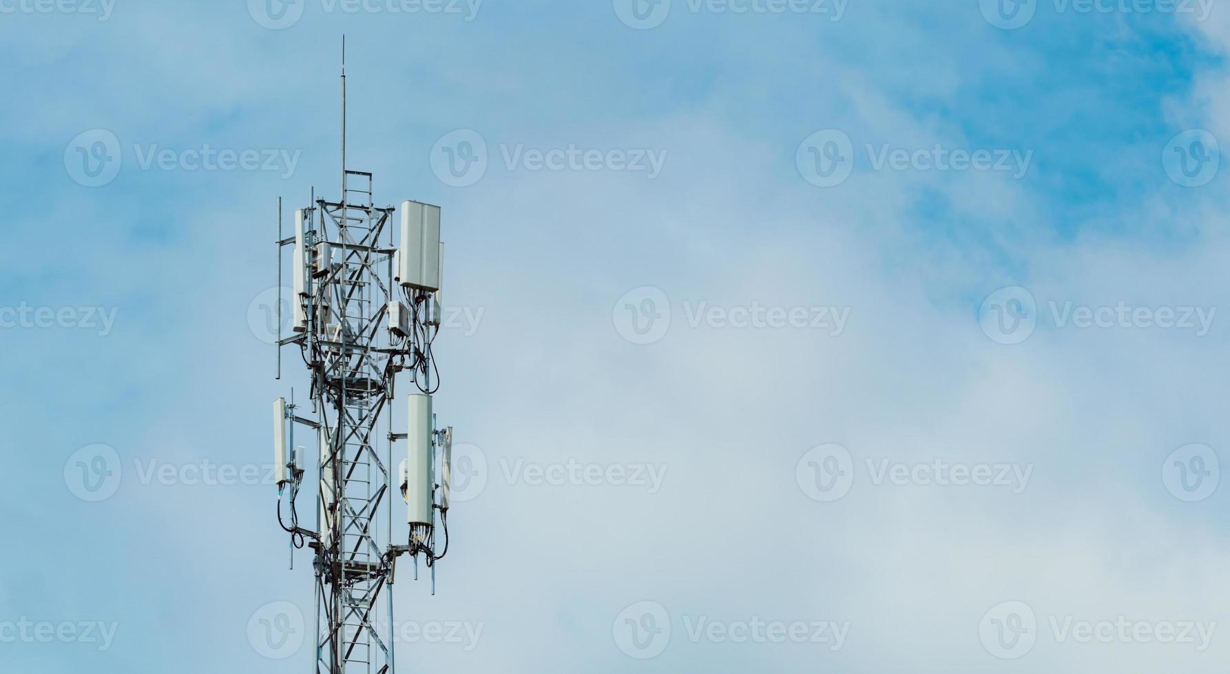 Telecommunication tower with blue sky and white clouds background. Antenna on blue sky. Radio and satellite pole. Communication technology. Telecommunication industry. Mobile or telecom 4g network. photo