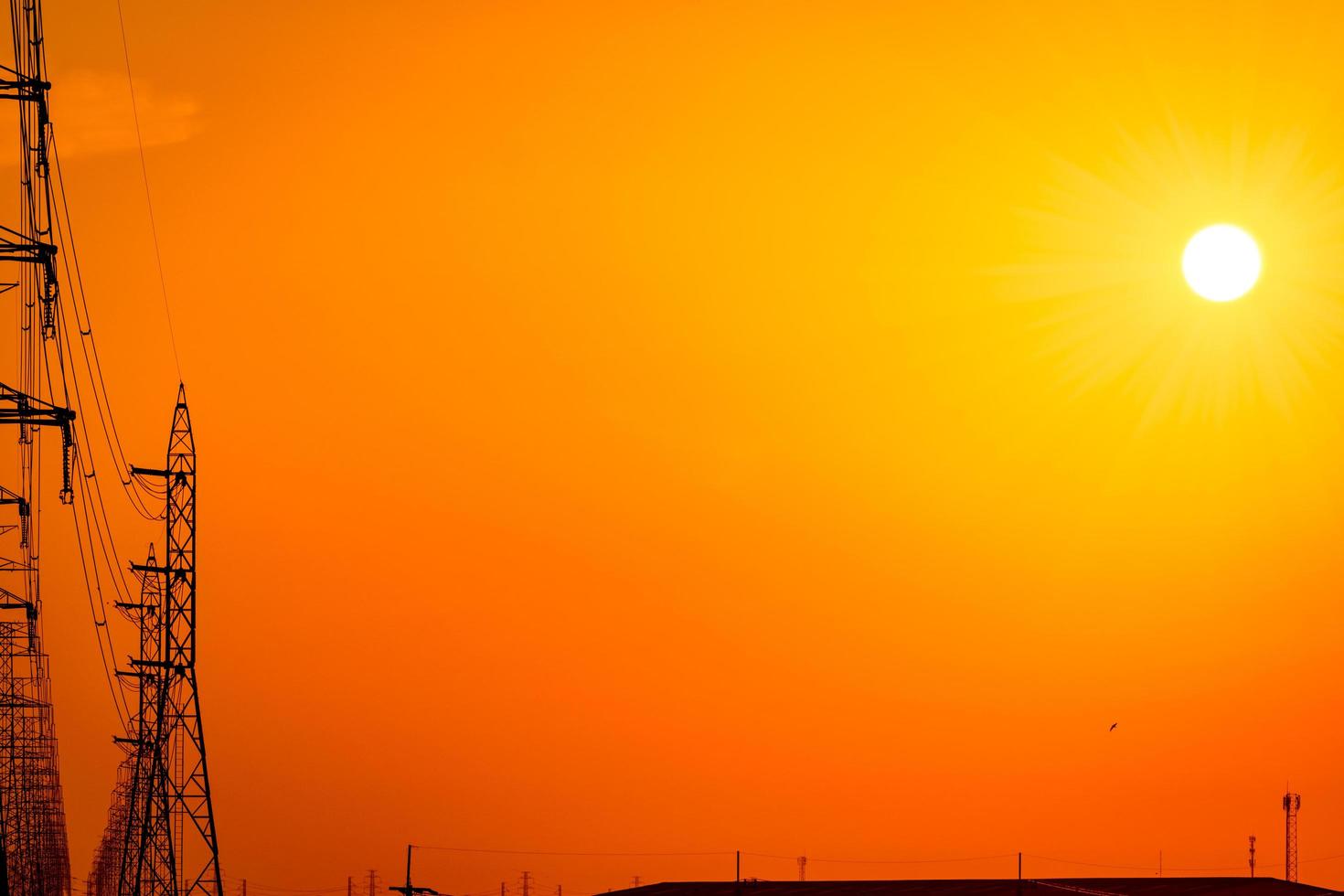 High voltage electric pole and transmission lines in the evening. Electricity pylons at sunset. Power and energy. Energy conservation. High voltage grid tower with wire cable at distribution station. photo