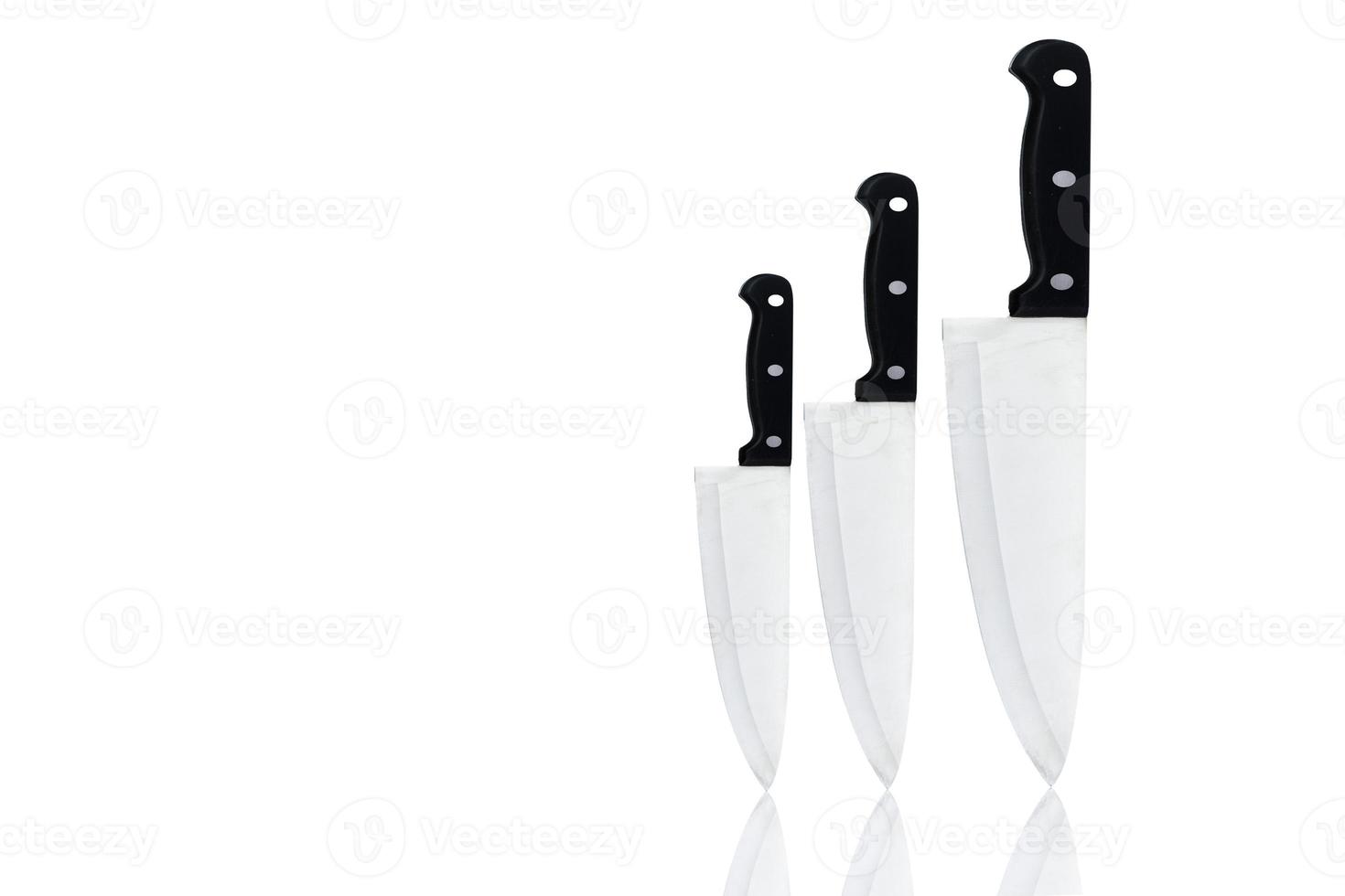 Set of new sharp chef knives with black handle isolated on white background. Stainless steel knife for home cook or for chef in restaurant kitchen. Butcher knife for carving food. Utensil in kitchen. photo