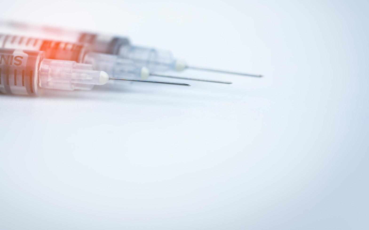 Single use syringe. Plastic insulin syringe. Needle for addict. Three insulin syringe with opened cover show sharp needles. Injection medicine. Medical equipment. Infection from reused syringe concept photo