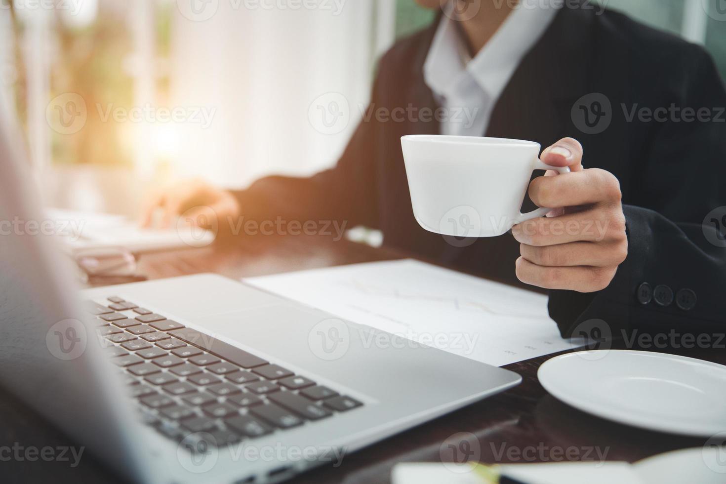 Young Businessman Analyzing Graph On Computer At Workplace photo