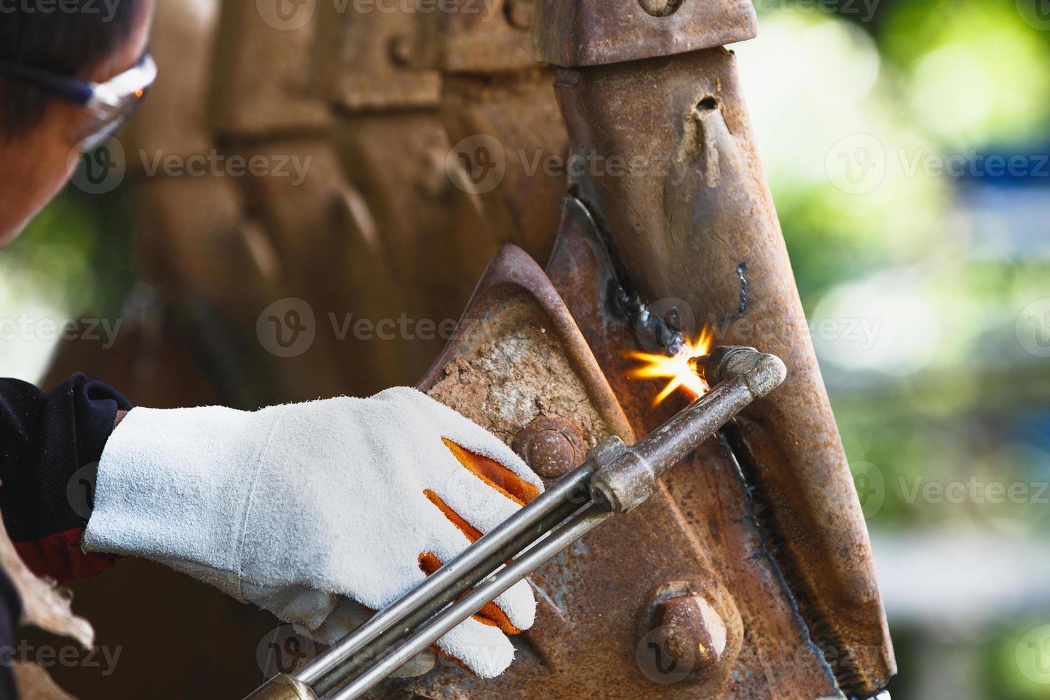 Cutting a steel with a gas torch.  Gas welding and oxy-fuel cutting are processes that use fuel gases and oxygen to weld and cut metals. photo