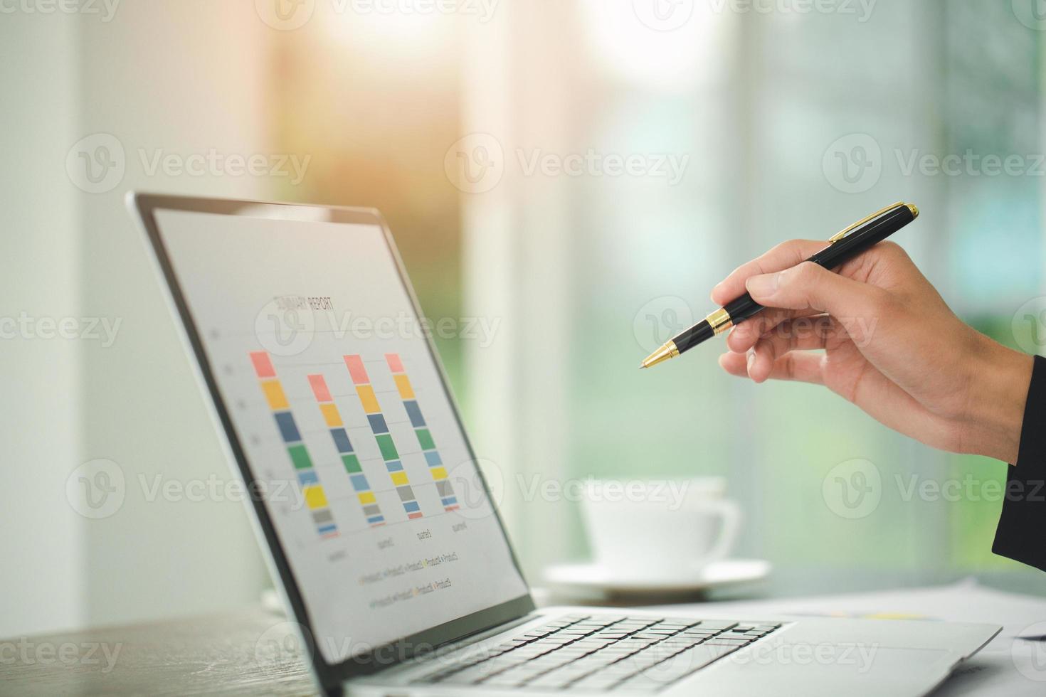 Young Businessman Analyzing Graph On Computer At Workplace photo