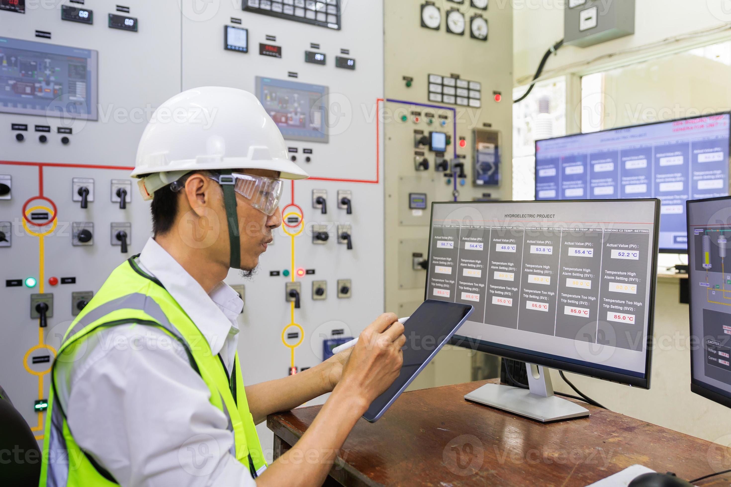Male engineerr working in electrical control room in the heavy factory