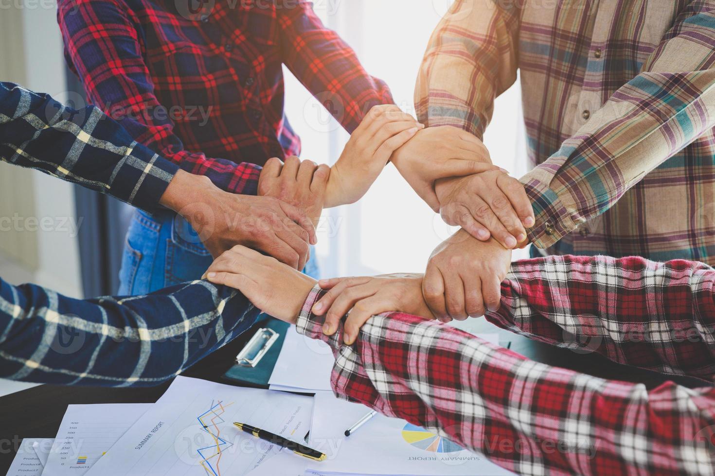 A diverse group of people connects their hands as a supportive sign expressing a sense of teamwork. Unity and togetherness. business teamwork. photo