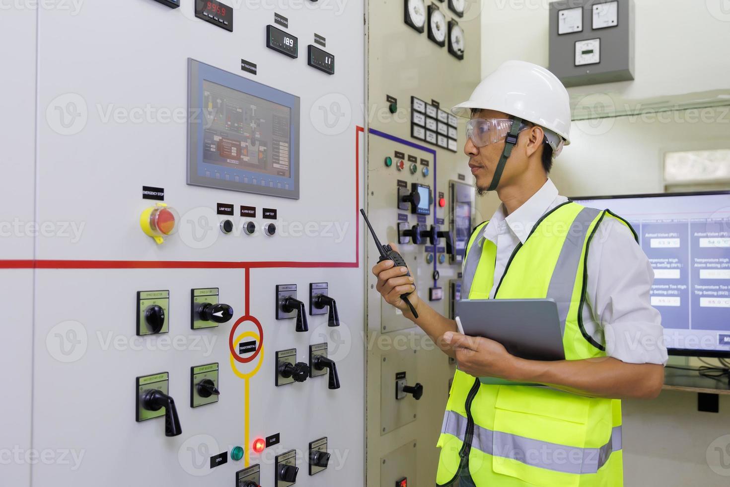 Experienced electrician working in power plant control room. Engineer