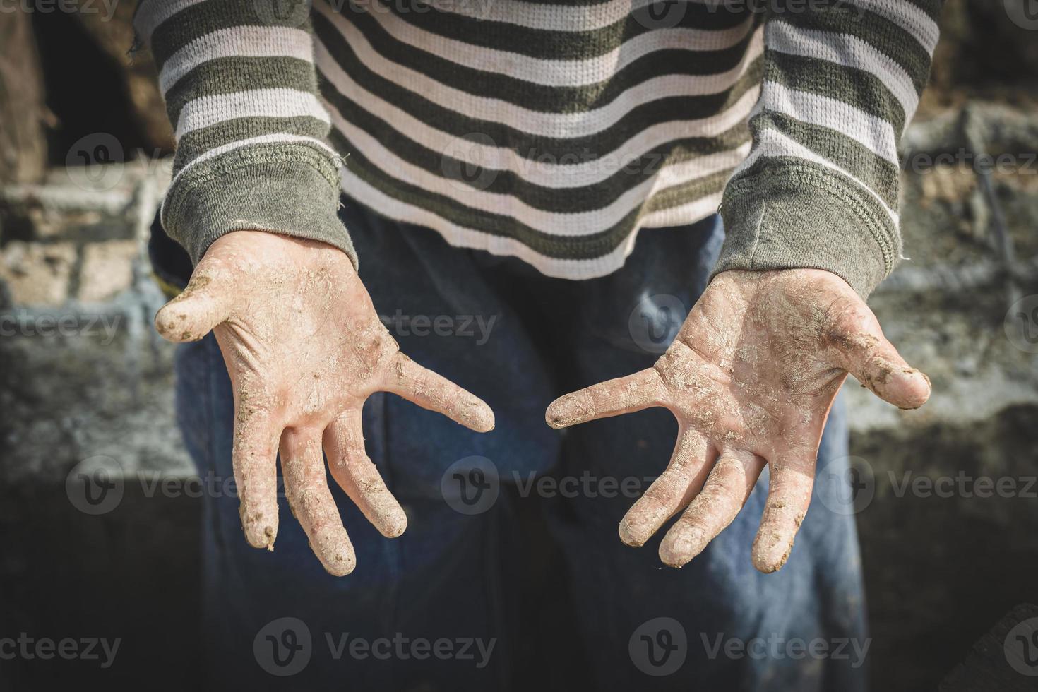 Stained hands are forced to work. The concept of anti-child labor. The abuse of labor. The oppression or intimidation of forced labor among children. photo