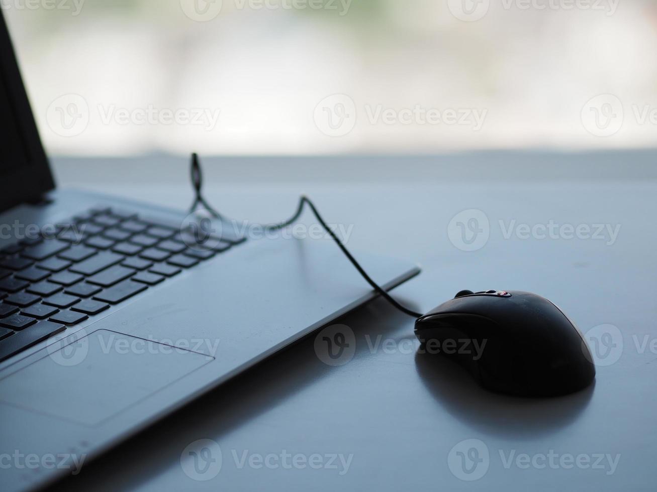 notebook with mouse on the table photo