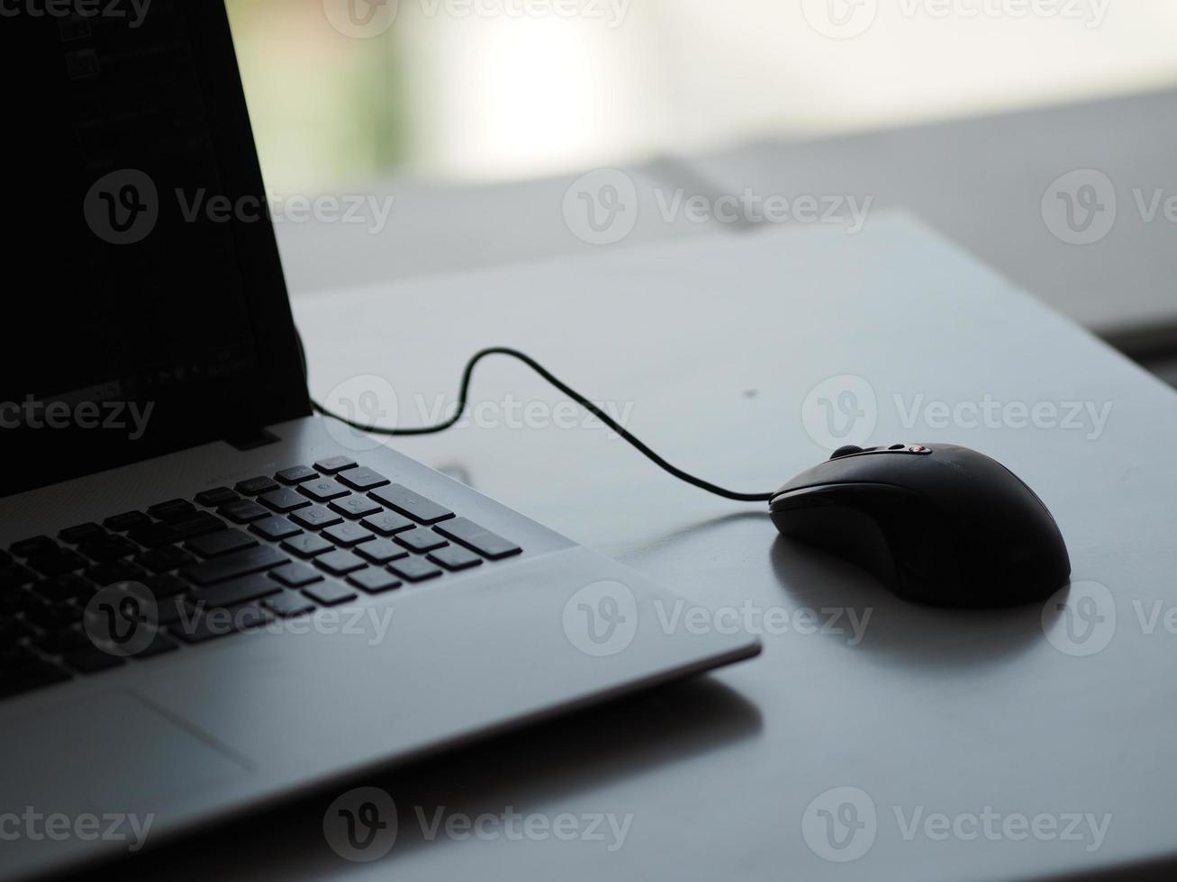 notebook with mouse on the table photo