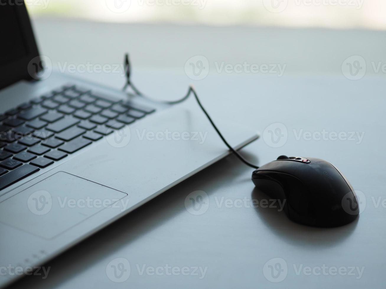notebook with mouse on the table photo