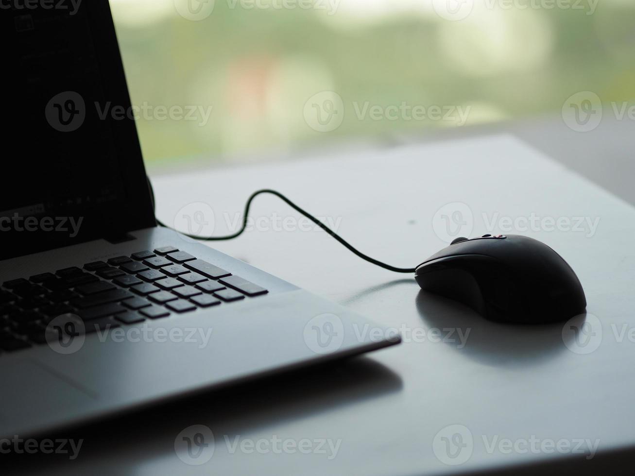 notebook with mouse on the table photo