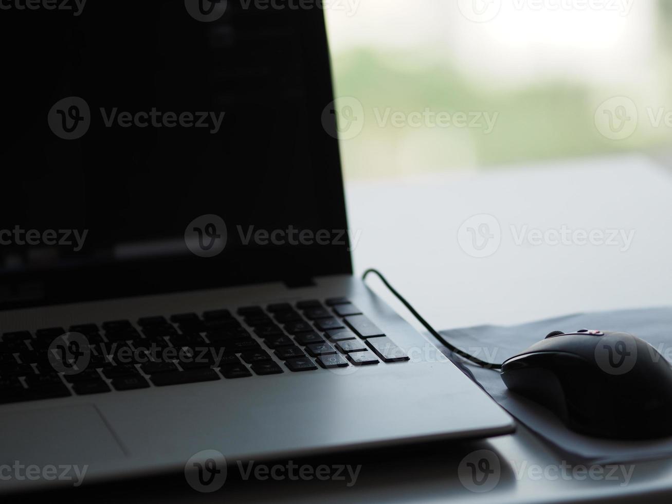 notebook with mouse on the table photo