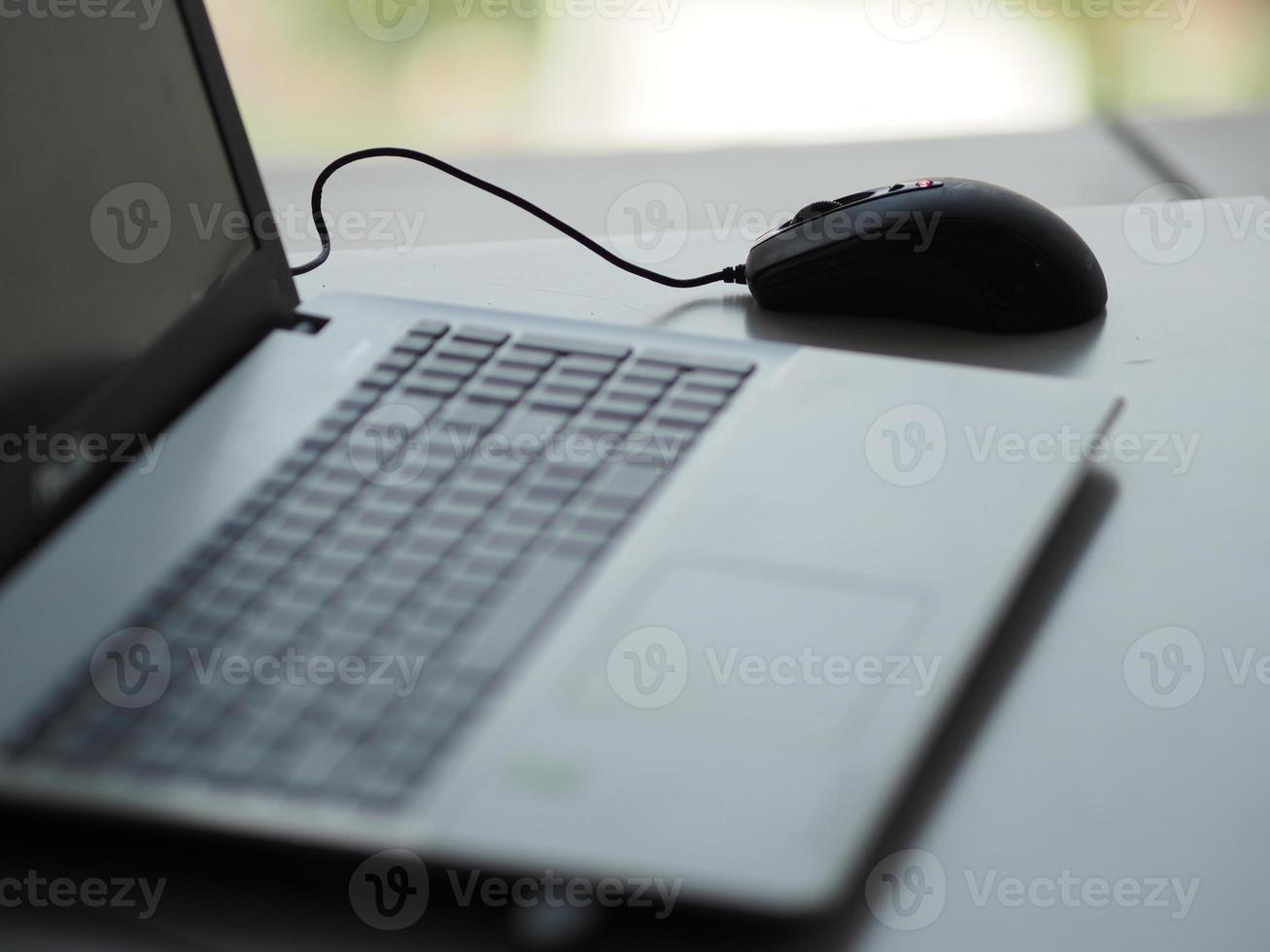 notebook with mouse on the table photo