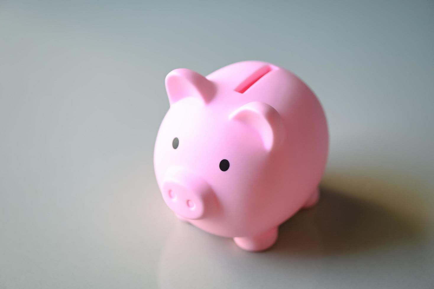 Piggy bank on floor background, pink piggy bank saving money for education study or investment concept photo