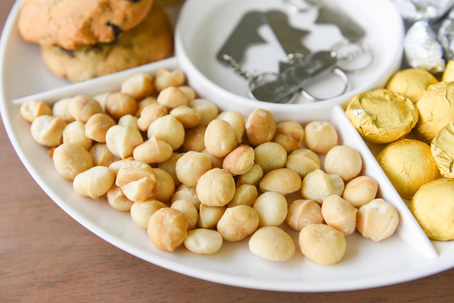 Set of macadamia nut packaging on tray plate natural high protein - cookies chocolate with macadamia nuts photo