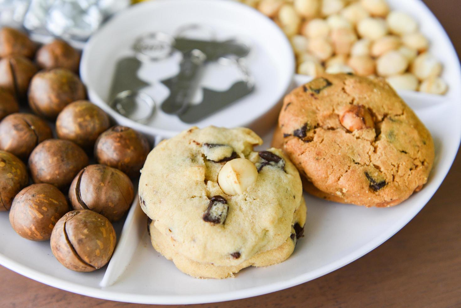 Set of macadamia nut packaging on tray plate natural high protein - cookies chocolate with macadamia nuts photo