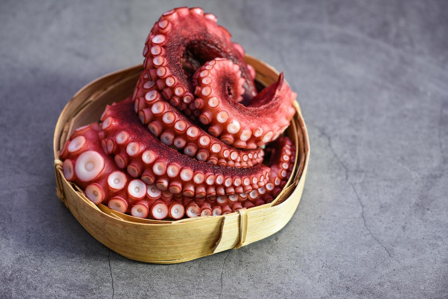 Boiled octopus tentacles on wooden tray, Octopus food cooked seafood squid cuttlefish dinner restaurant photo