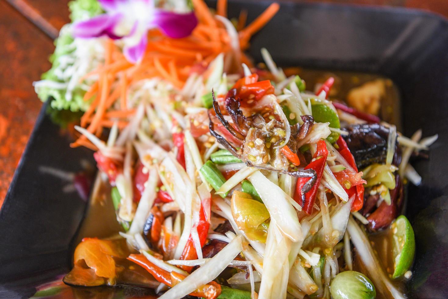 Green papaya salad with crab Thai food, cpicy salad herbs photo