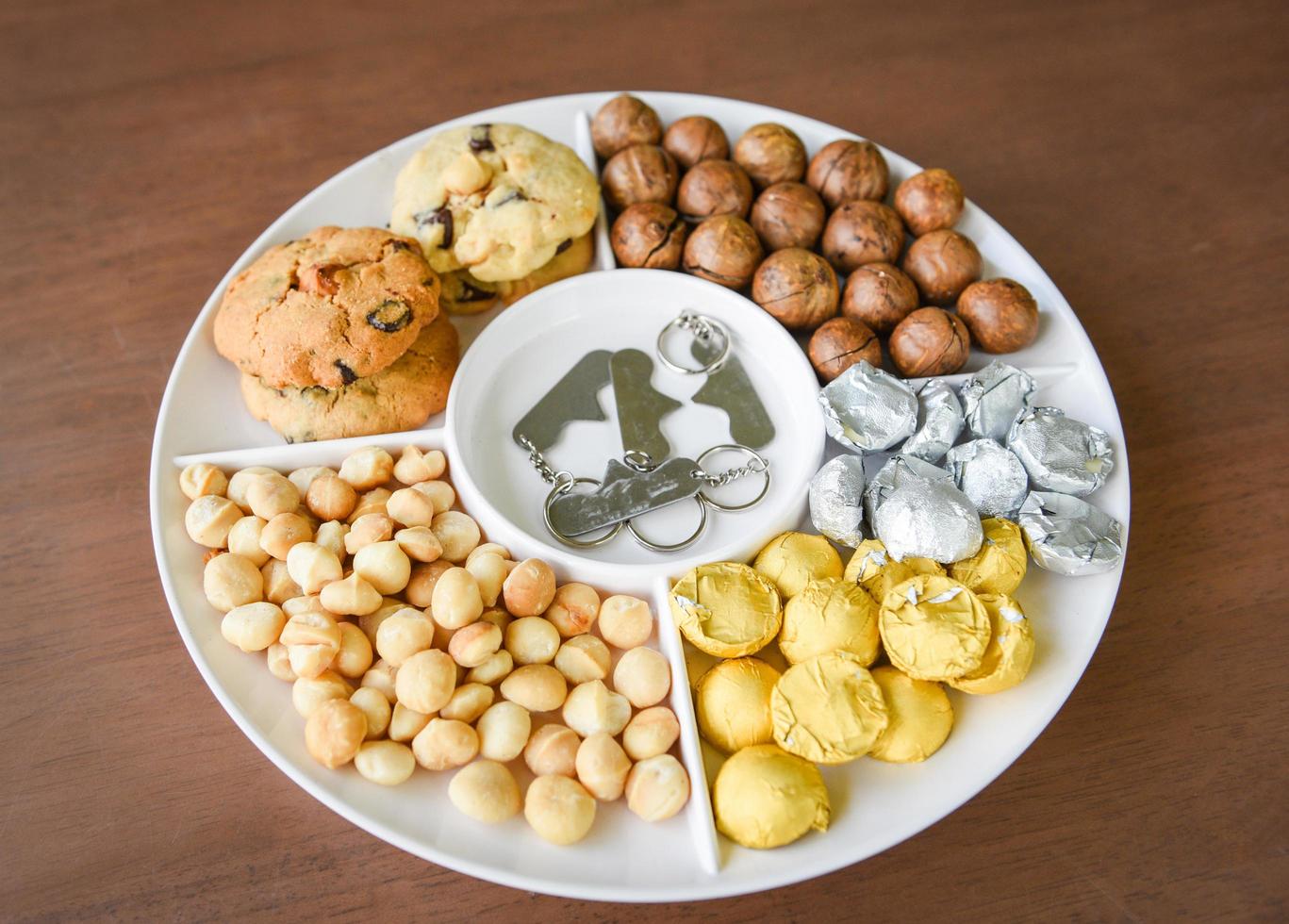 Set of macadamia nut packaging on tray plate natural high protein - cookies chocolate with macadamia nuts photo