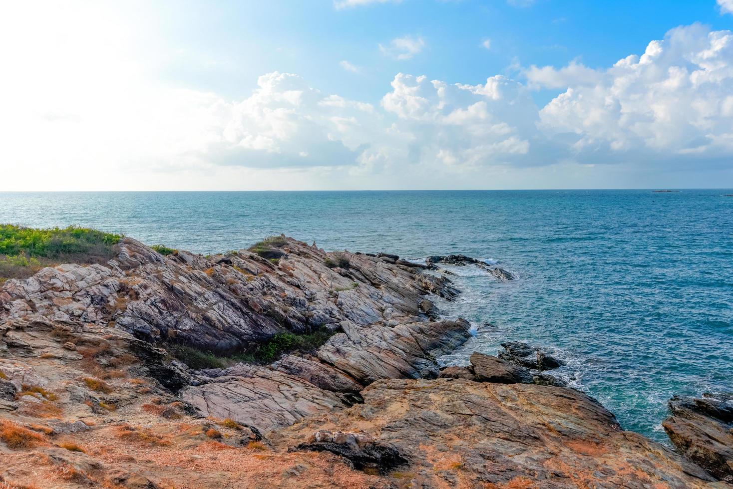 View of sea waves and fantastic rocky coast landscape - Seascape rock tropical island with ocean and blue sky background in Thailand photo