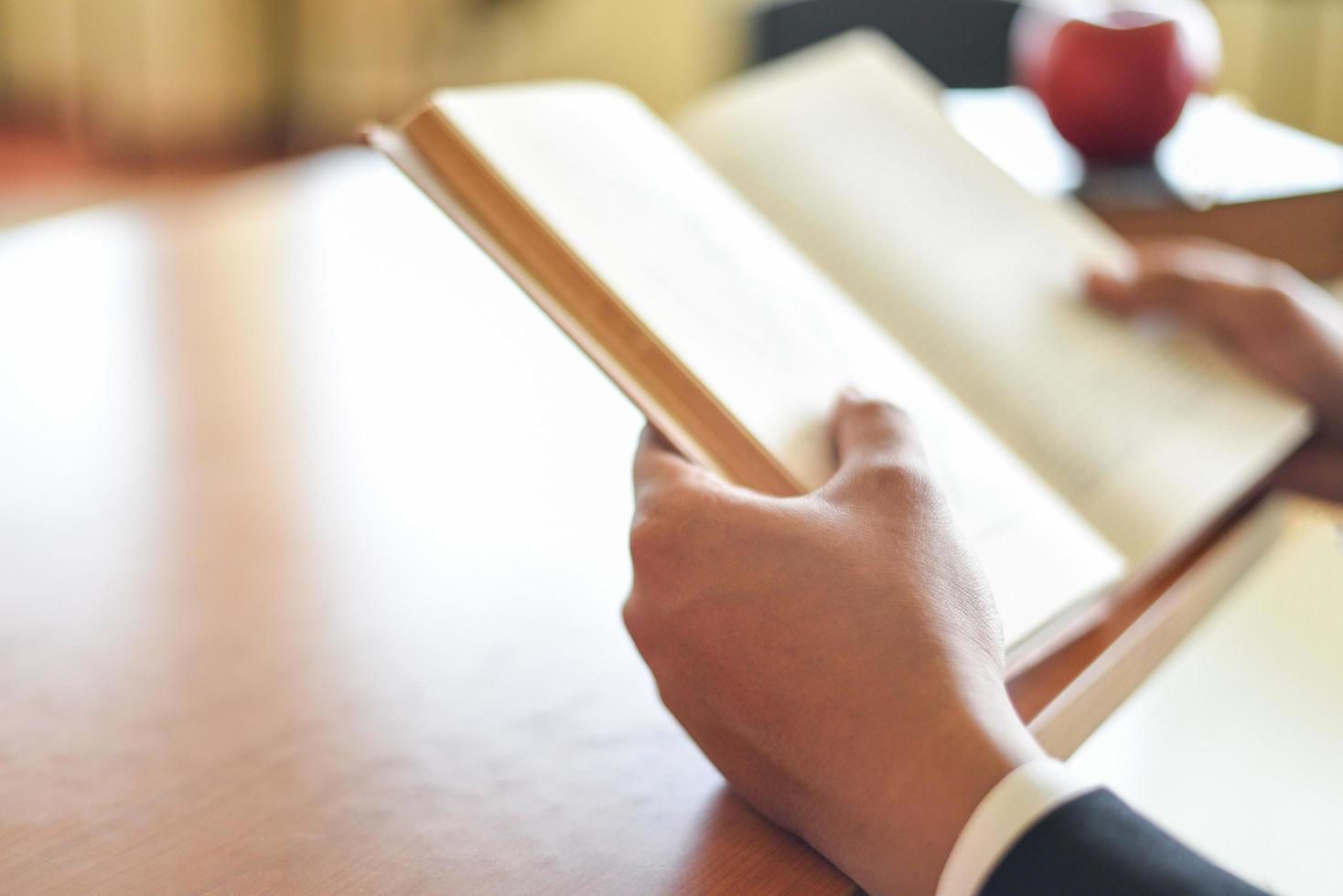 Business man or student holding a book on hand - Business education study concept man reading book on the table photo