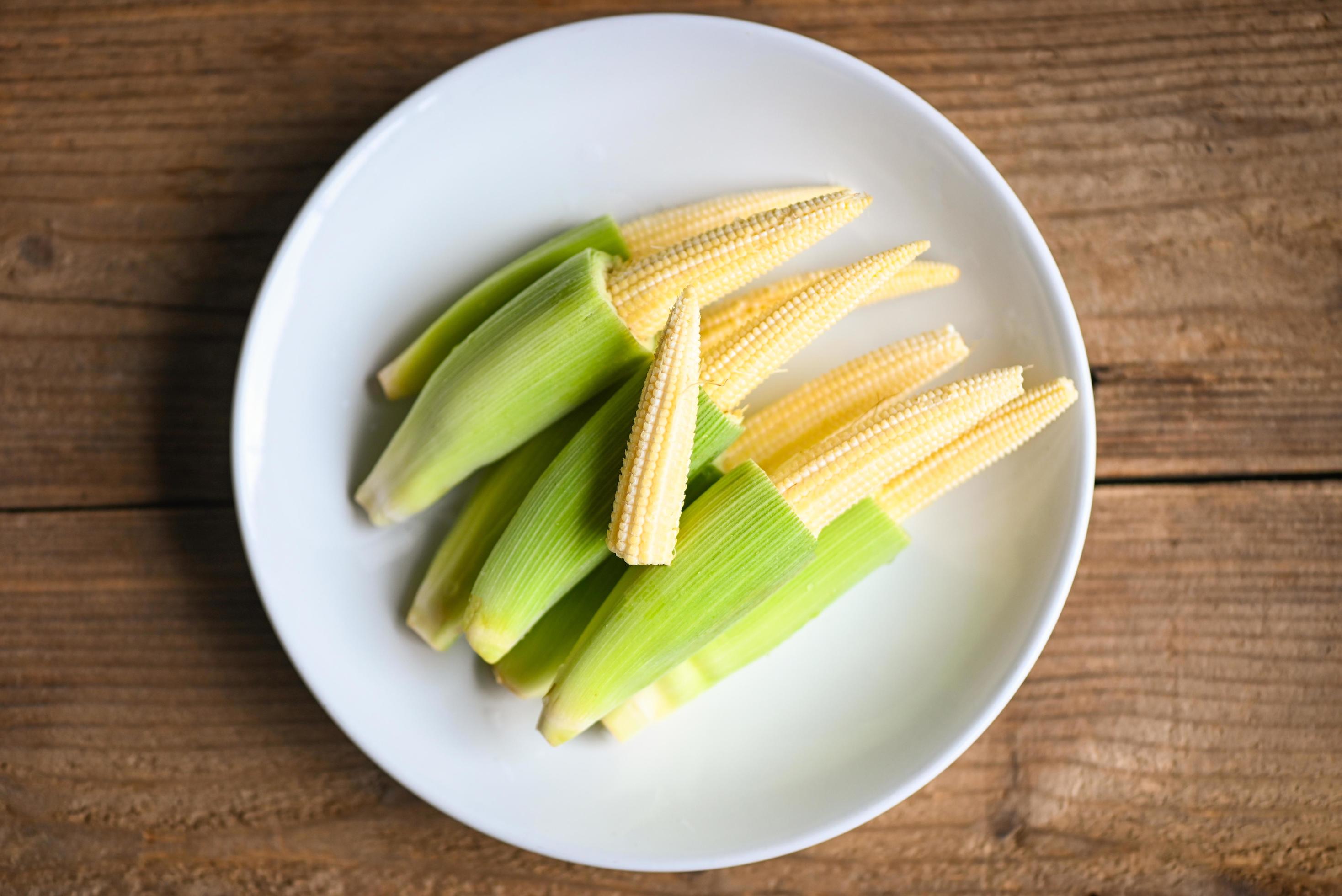 Baby corn on white plate, Fresh young baby corn for cooking health food