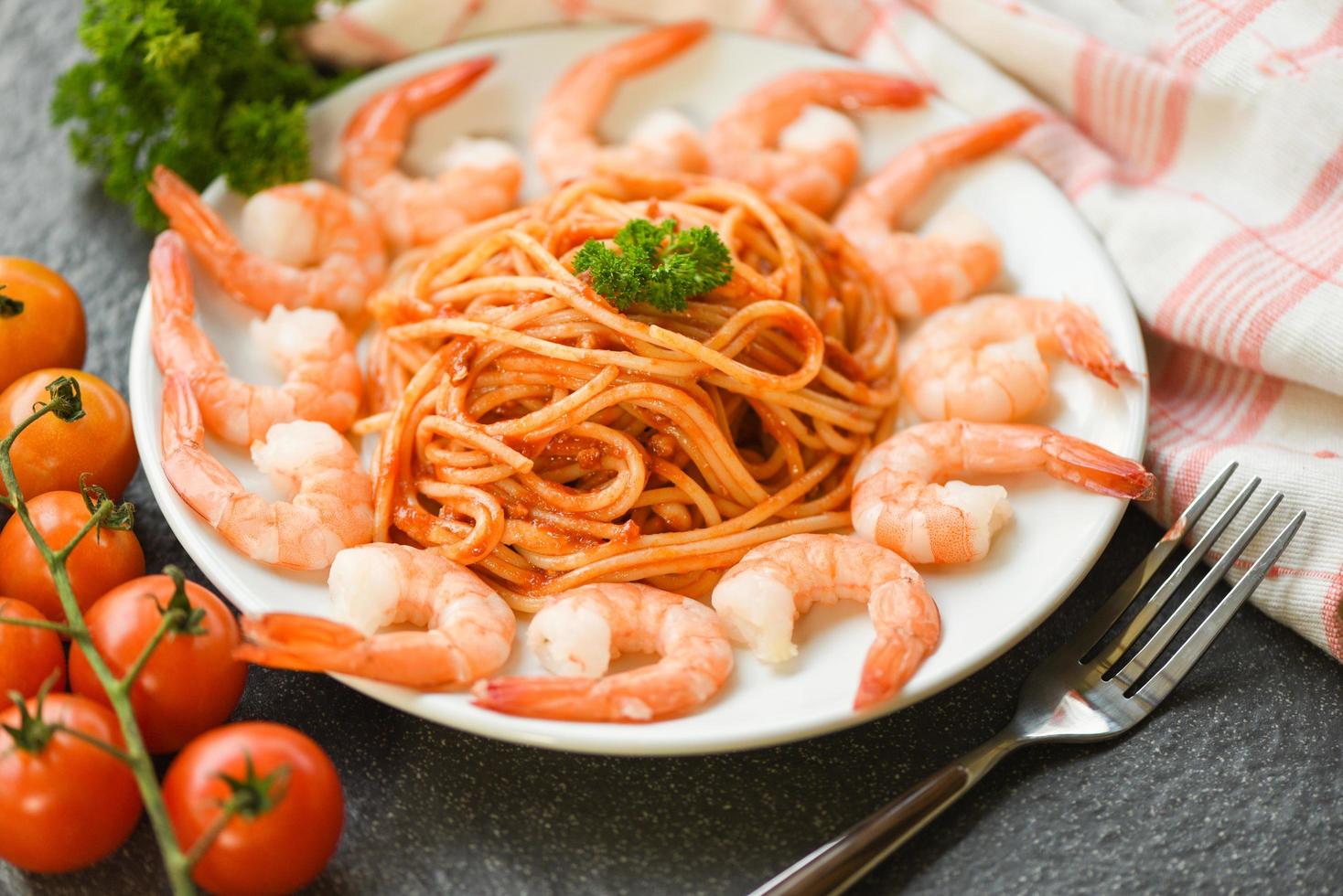 Spaghetti bolognese italian pasta with shrimp prawn served on white plate with tomato parsley in the restaurant italian food and menu concept spaghetti seafood photo