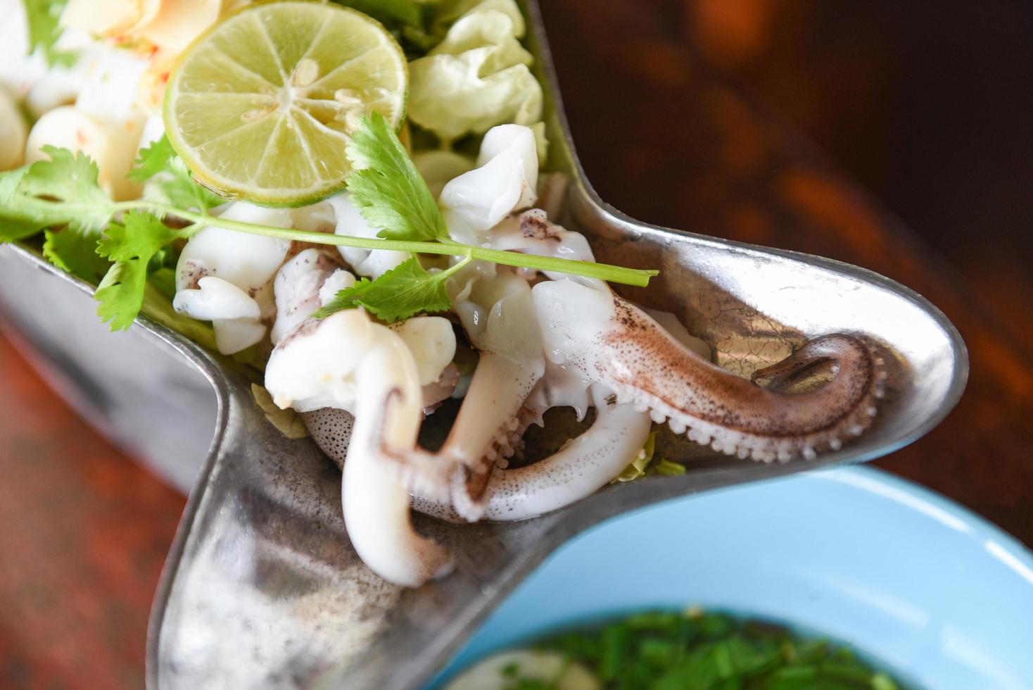 Steamed Squid with Lemon, hot and spicy squid steamed with lime - Thai food photo