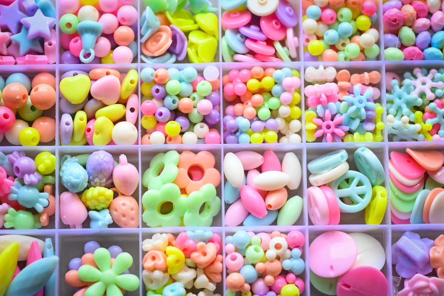 Various Bracelets colorful plastic beads made Cartoon style hand made in box. Variety of shapes and colors to make a bead necklace or a string of beads for women, diy concept photo