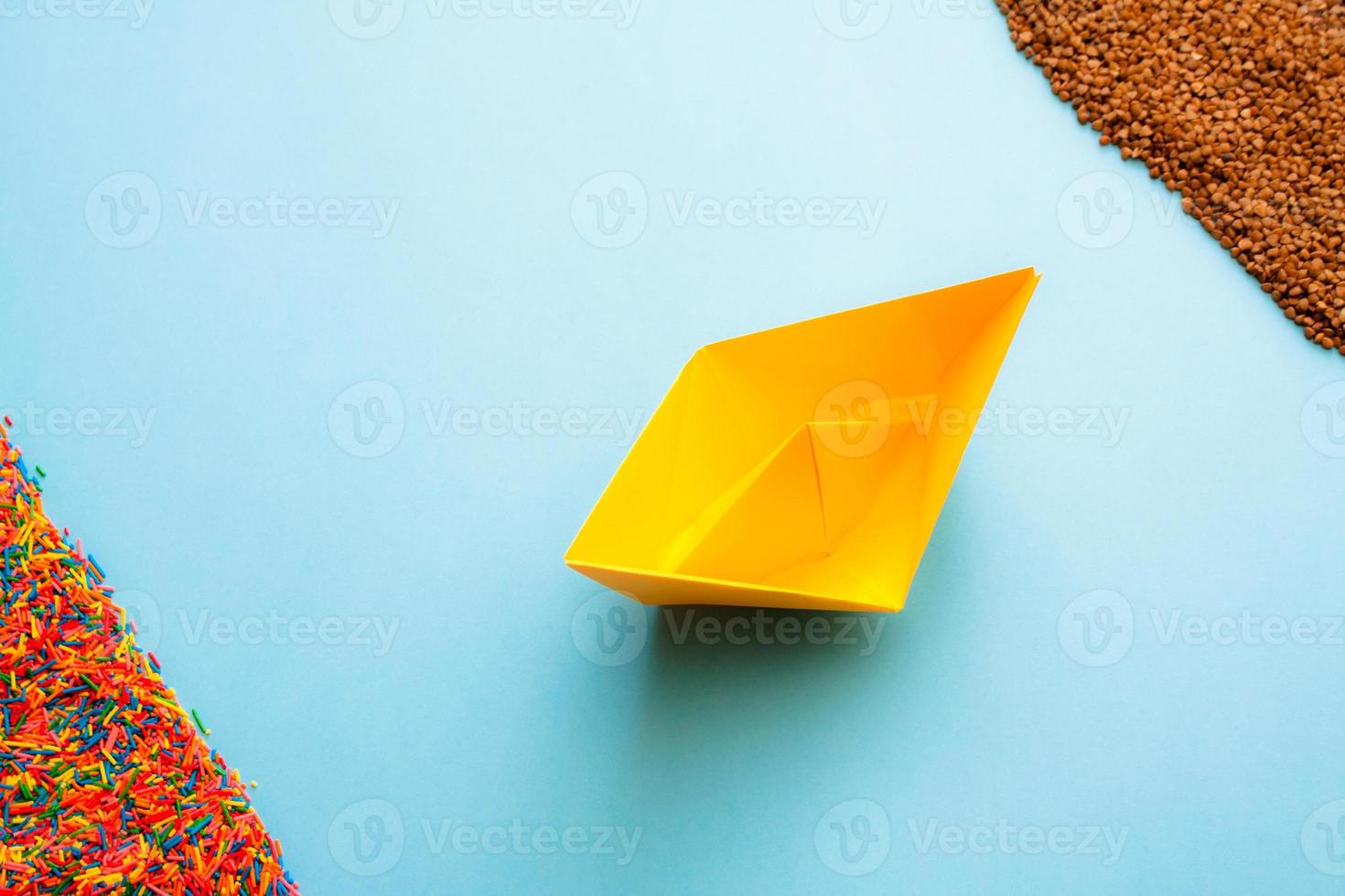 Healthy eating and healthy lifestyle concept flat lay. Paper boat sailing from sweet to buckwheat. photo