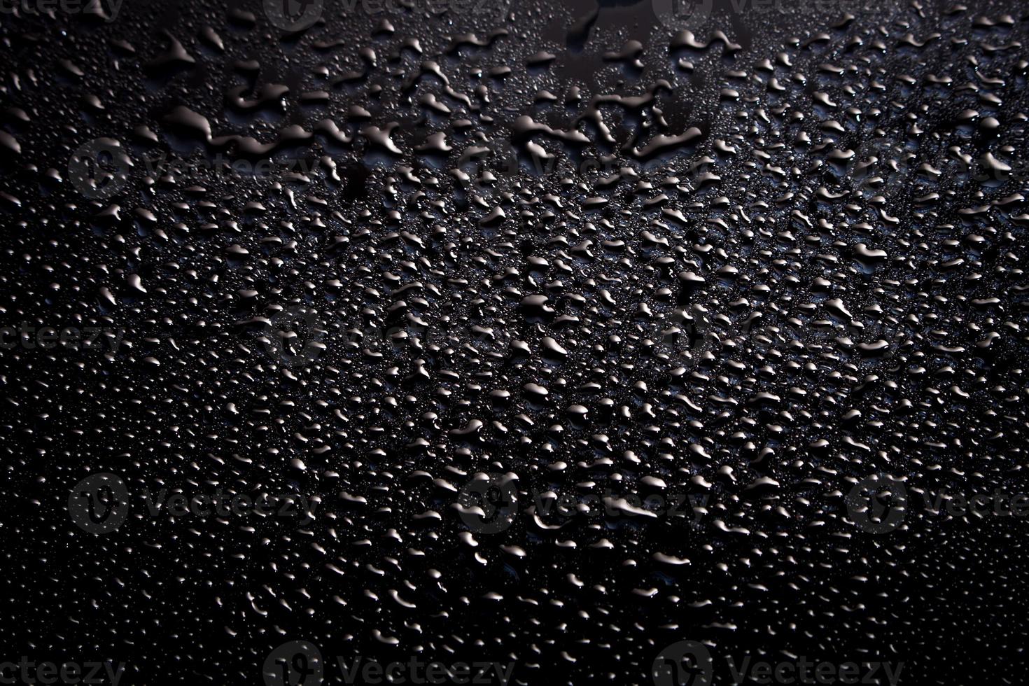 Black abstract background with water drops. Wet black texture. photo