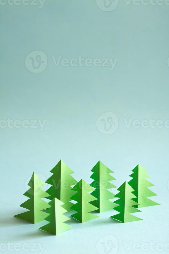 Paper forest with free copy paste space for text. Green paper trees on blue background. photo