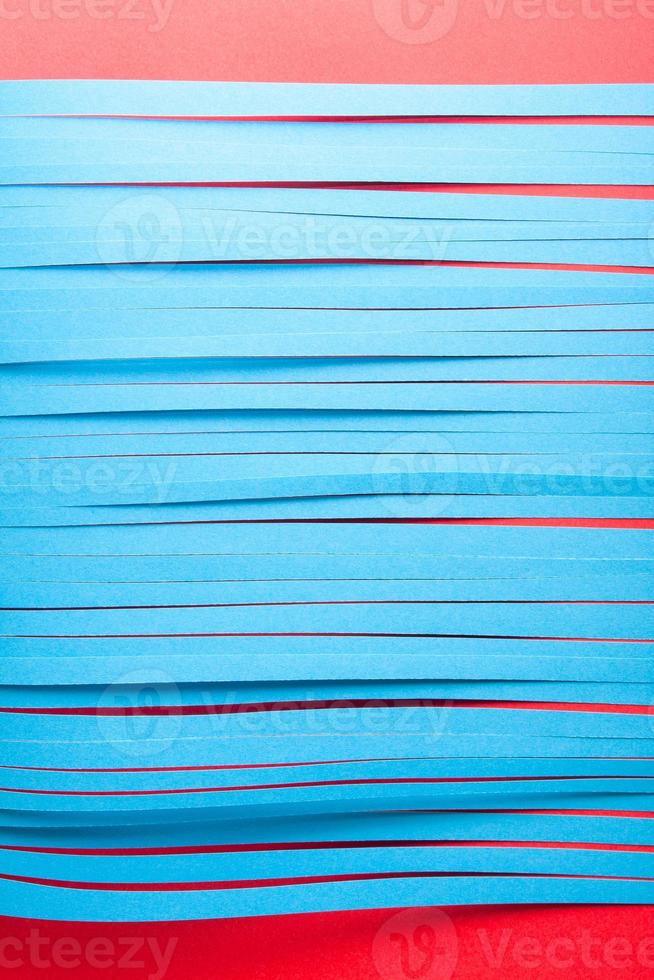 Blue cit paper strips background. Simple color paper background in blue and red. photo