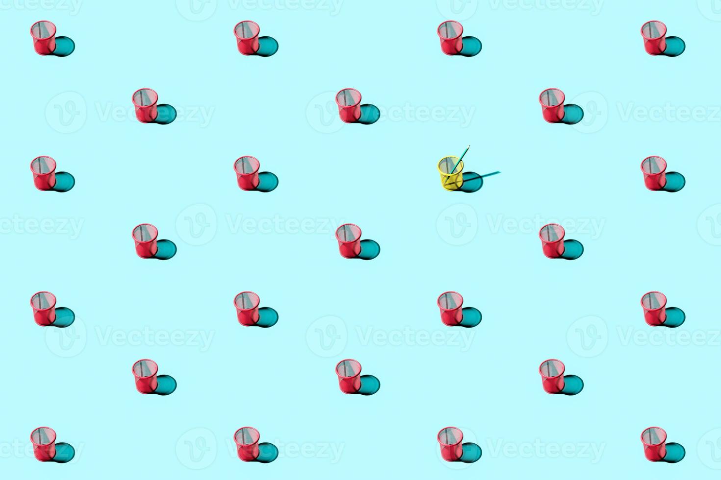 Simple repetitive pattern made of red mesh pencil cups on blue background. photo