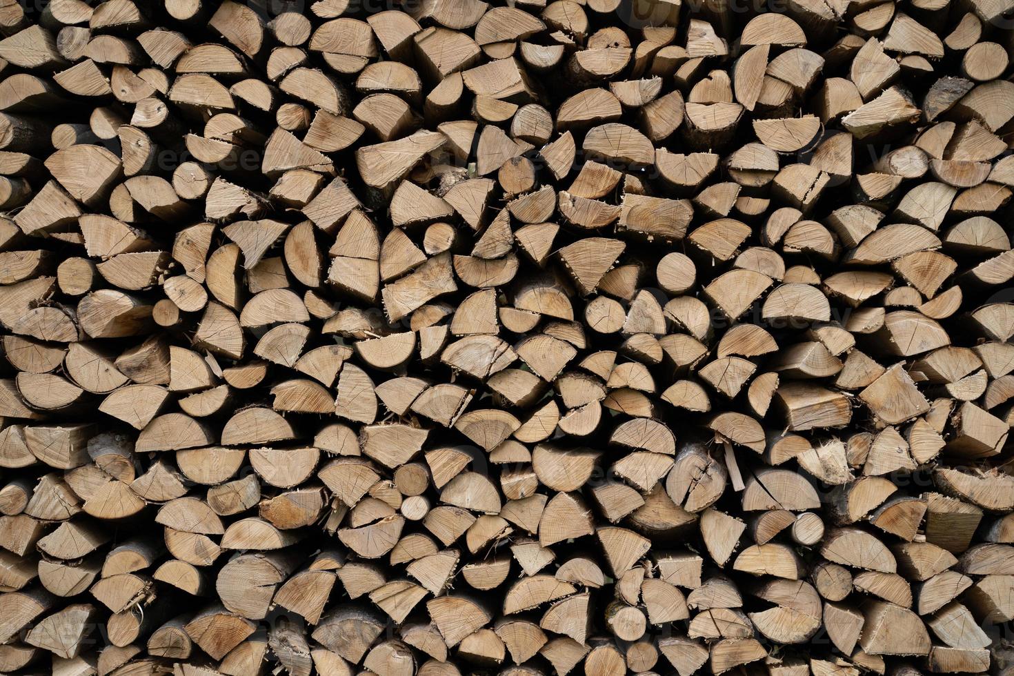 Gray and brown chopped stacked firewood background photo