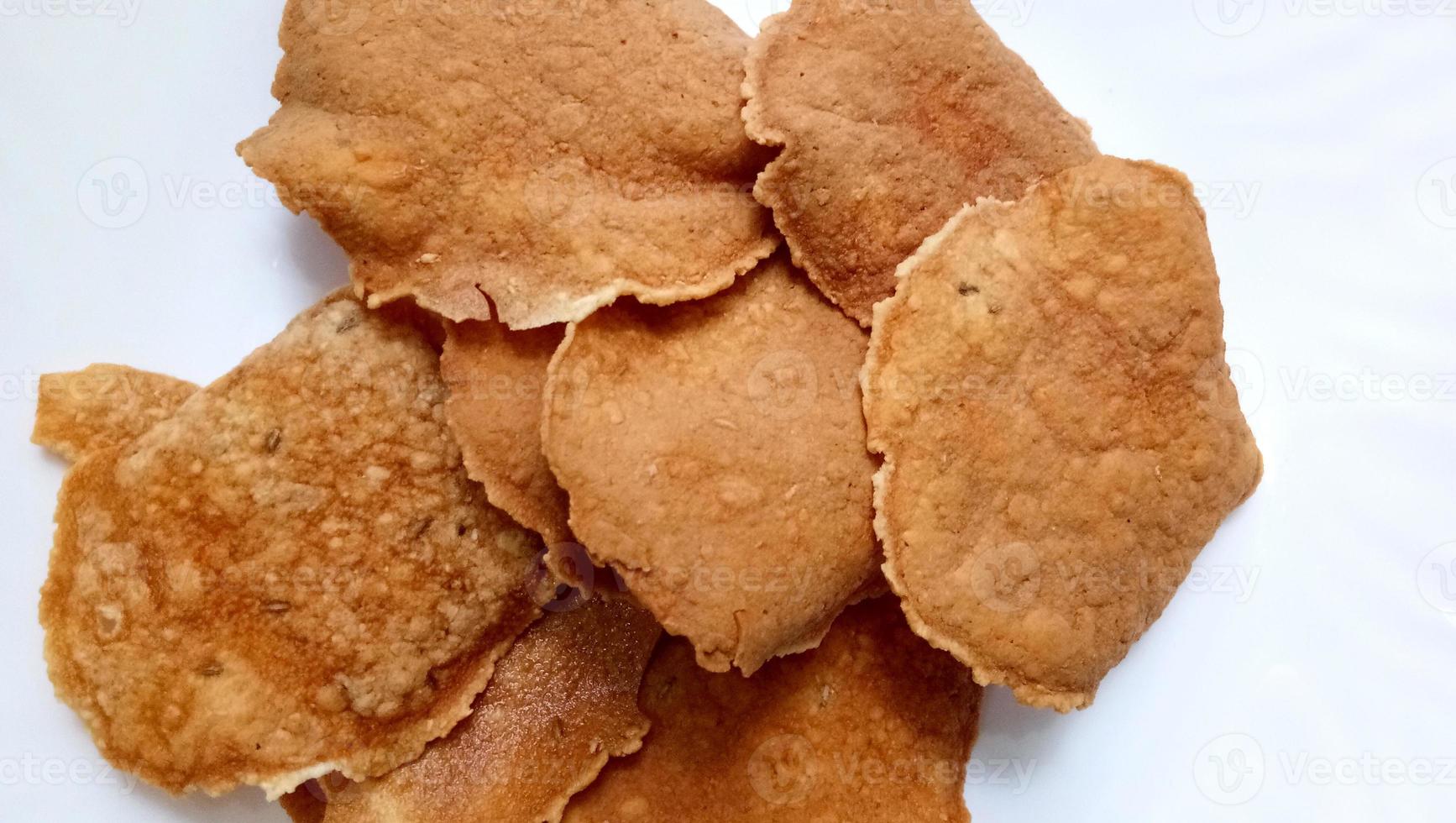 Indian crunchy fried snack papad or Papadam made of rice floor served in a plate. Also known as khichiya Papad. photo