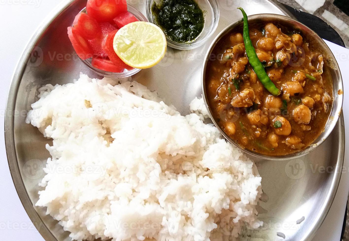 CHICKPEAS MASALA WITH RICE - Chole masala curry and cooked plain white rice, chole chawal or chole rice, traditional north indian lunch, dinner menu photo