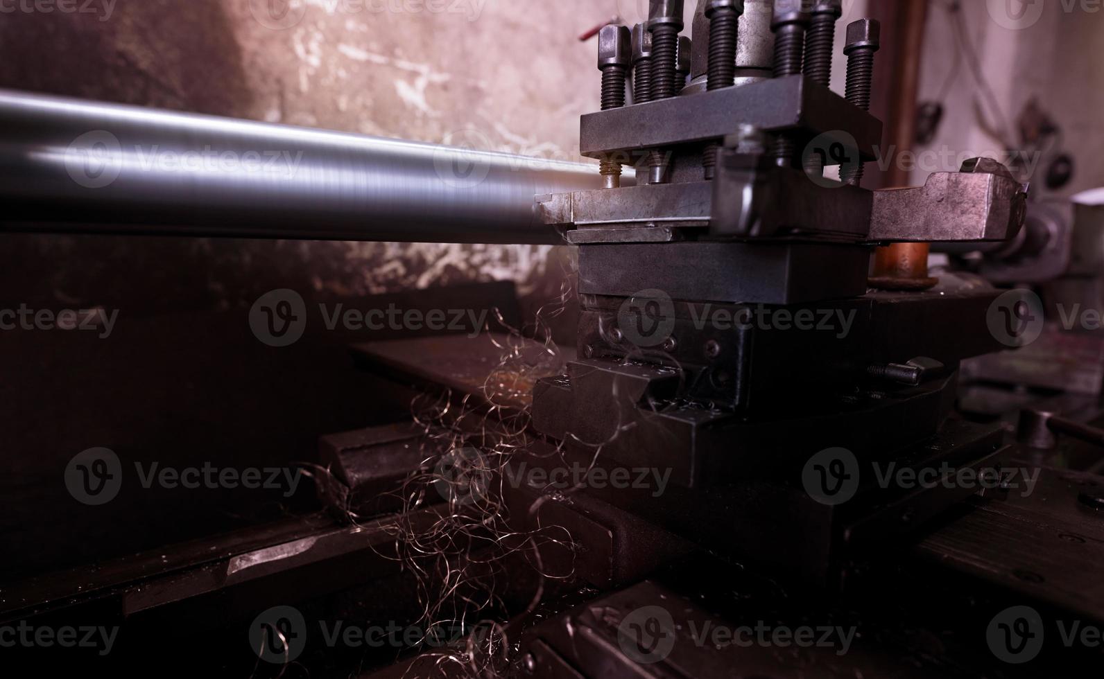 Lathe machine working in factory. Lathe turning machine for metalwork. Heavy machinery manufacturing. Machine for milling metal. Manual lathe machine. Safety in industrial workplace. Steel industry. photo