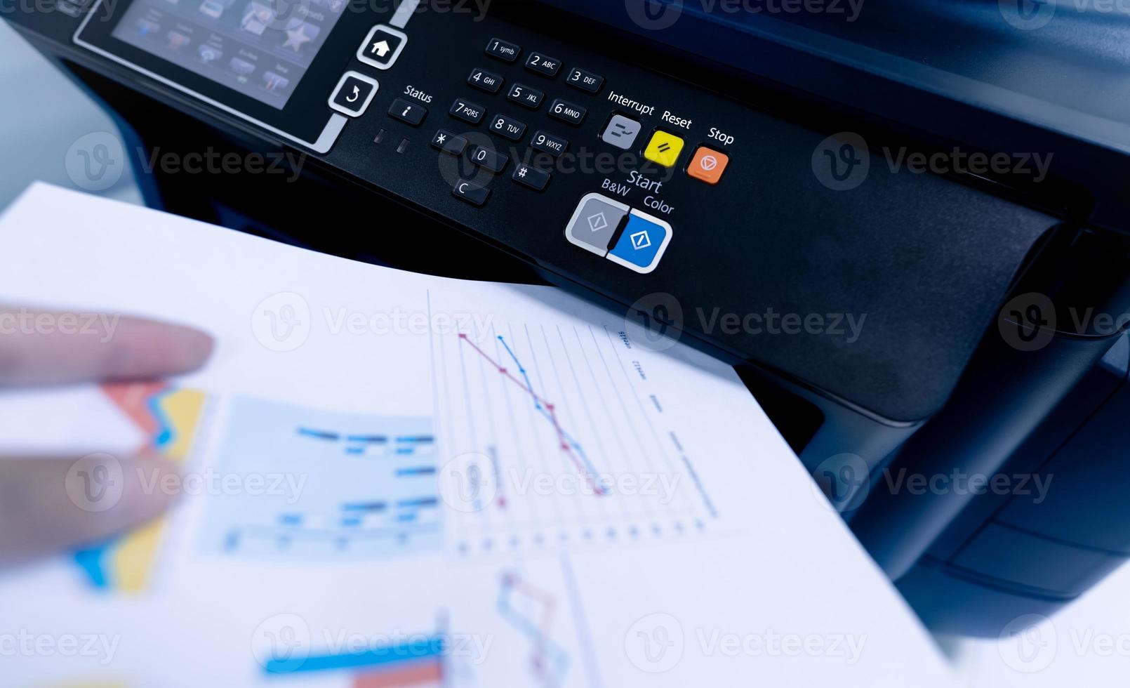 Office worker print paper on multifunction laser printer. Copy, print