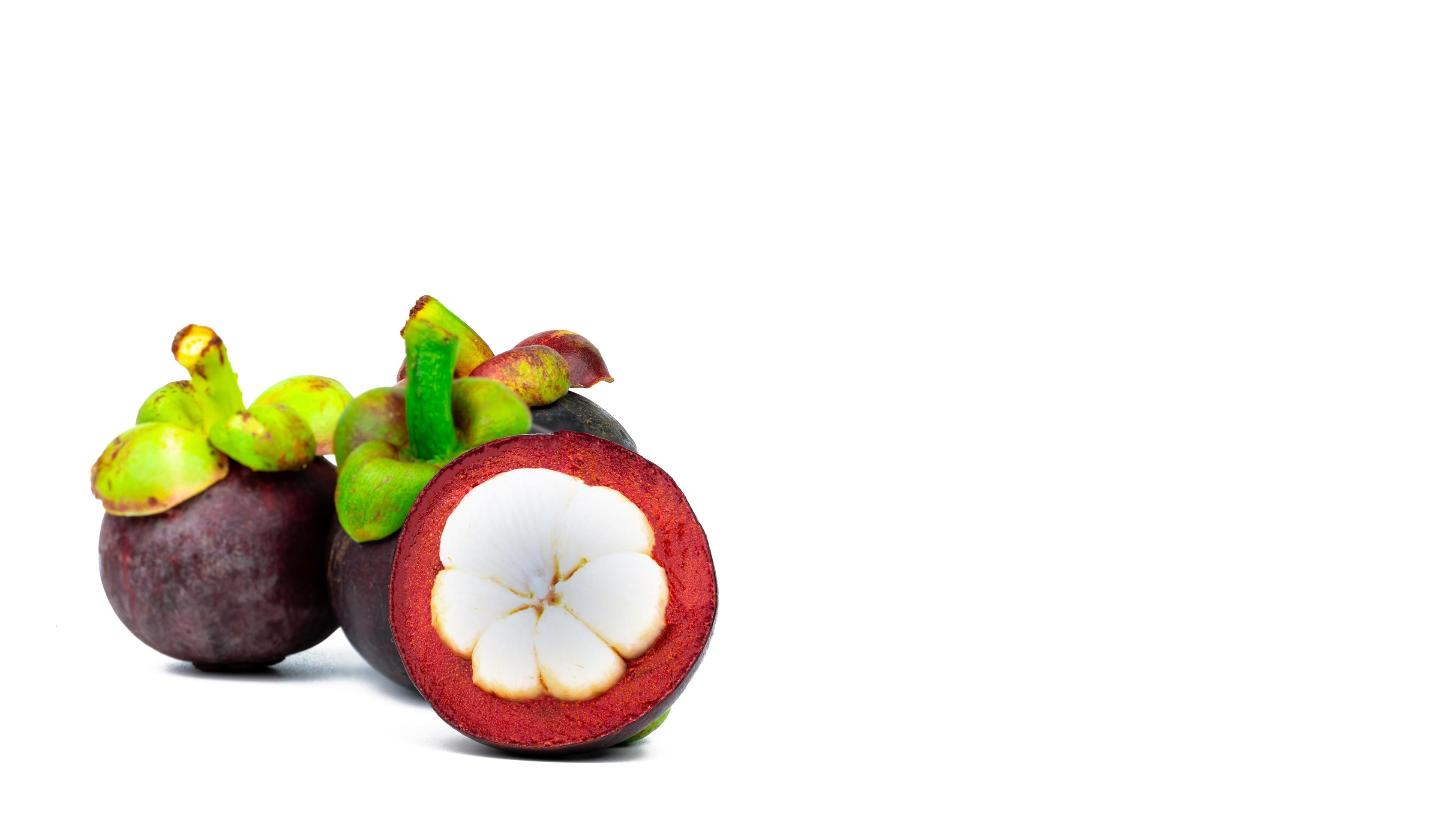 Three whole purple mangosteen and another cross section isolated on white background. Tropical fruit from Thailand. The queen of fruits. Asia fresh fruit market. Natural source of tannin and xanthones 7766856 Stock