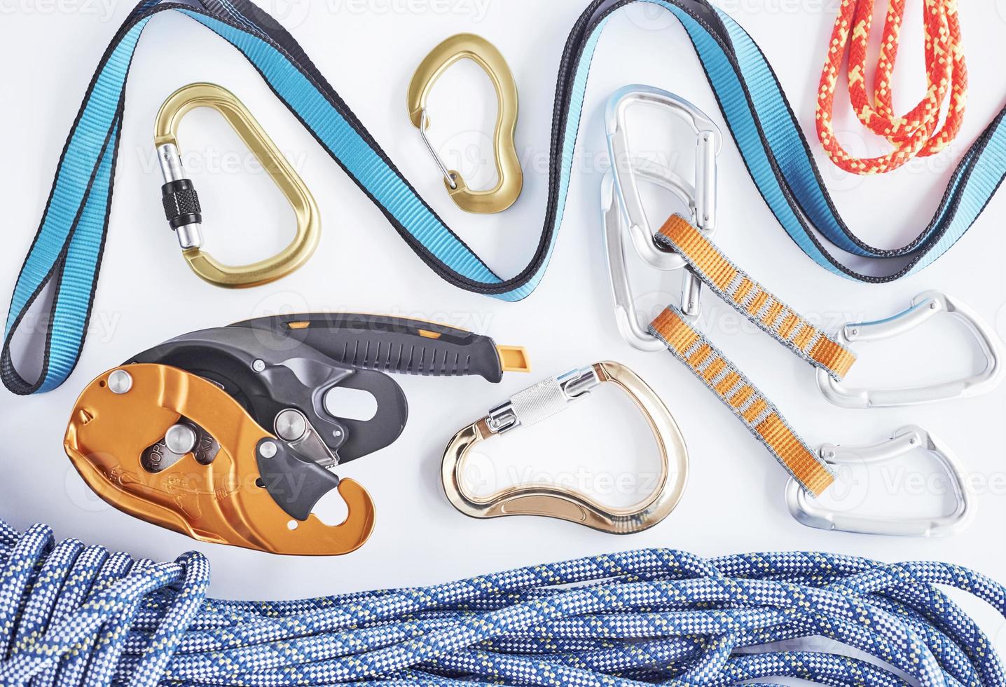 For brave people. Top view. Climbing equipment for the safeness lying on the white table. Conception of extreme sports photo