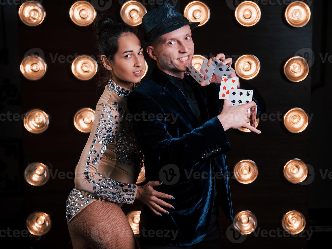 Passion in work and in love. Happy couple posing for the portrait. Family business of magician tricks and shows photo