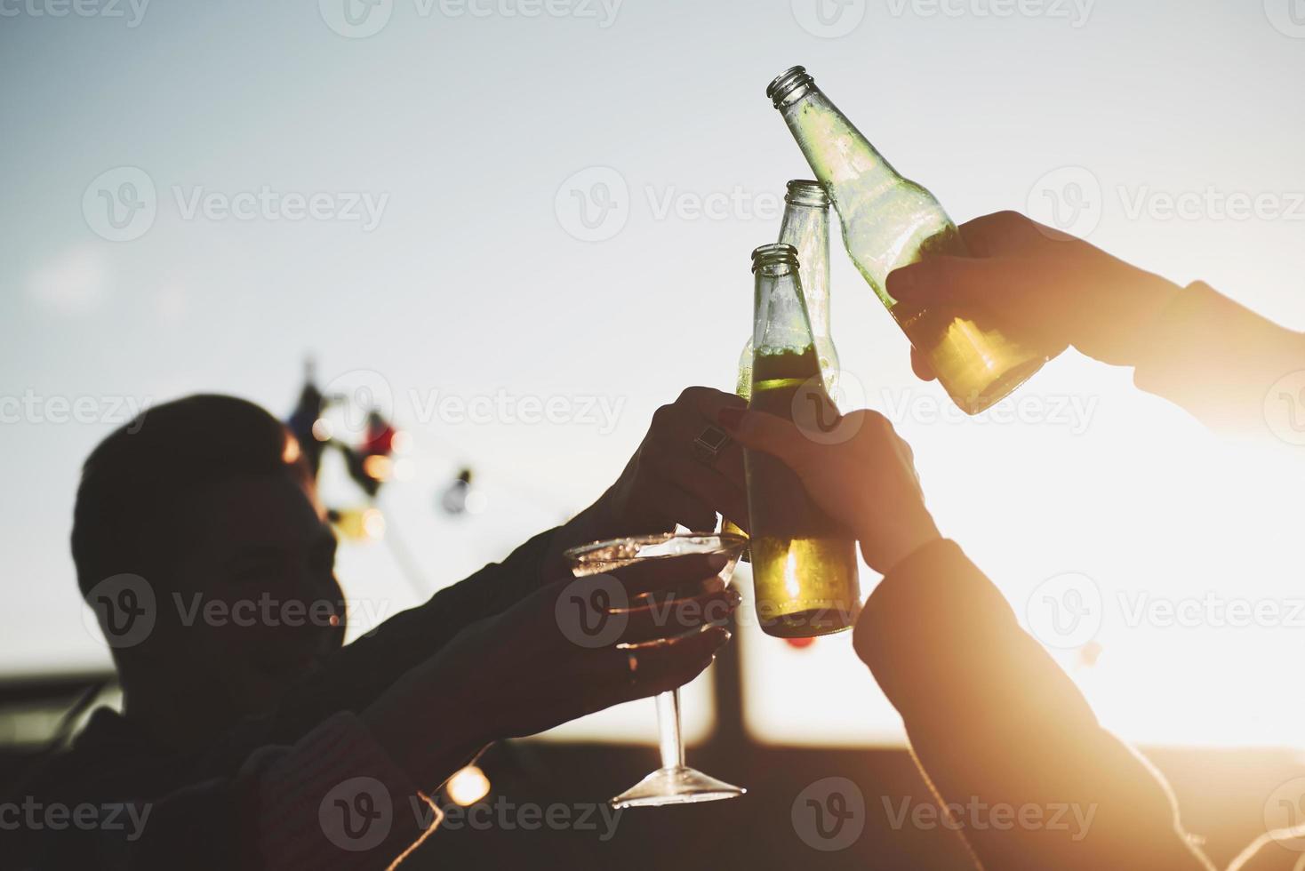 Daylight going through the glass. It's rooftop party. Group of friends have holidays at sunny autumn day photo