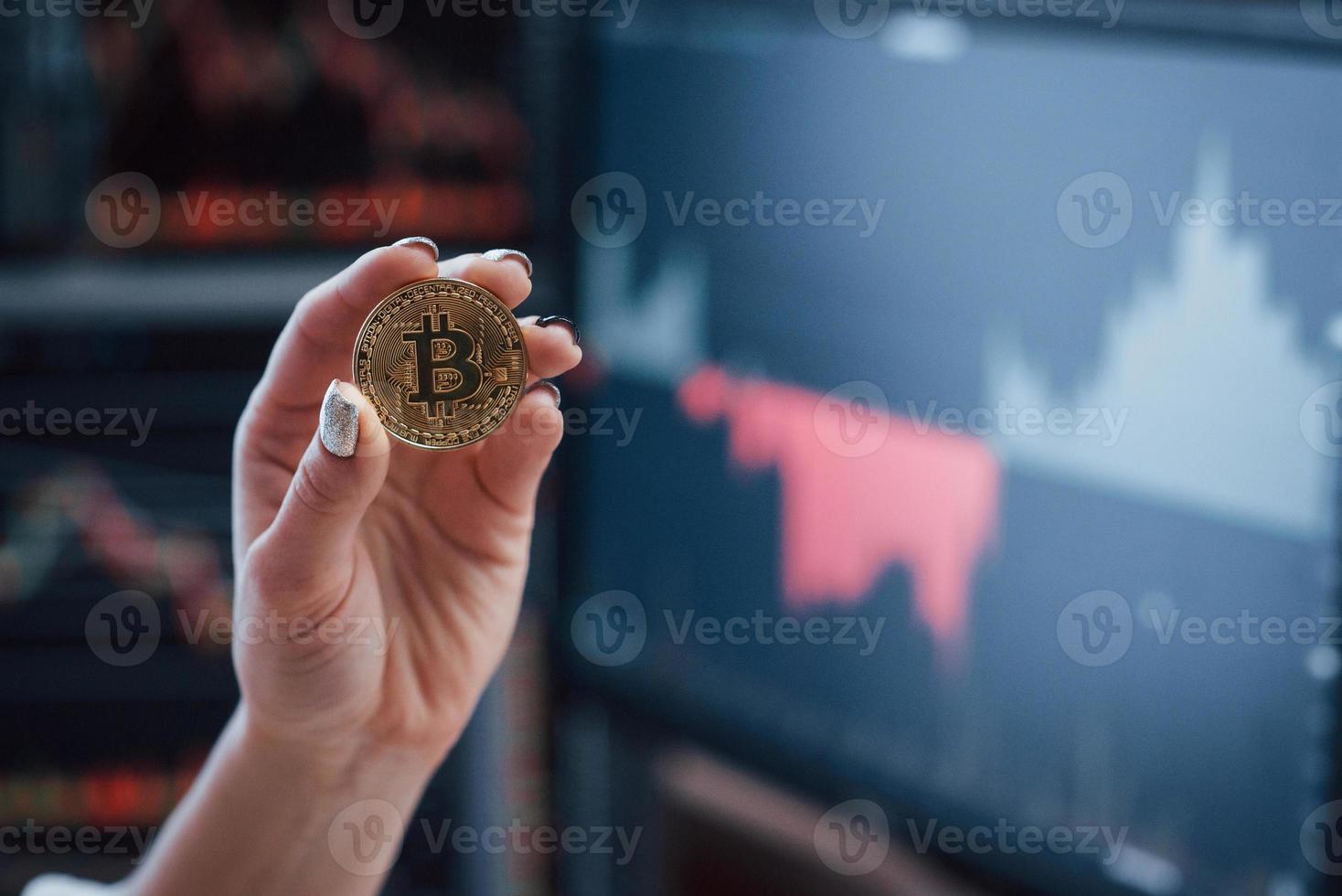 Team of stockbrokers are having a conversation in a office with multiple display screens photo