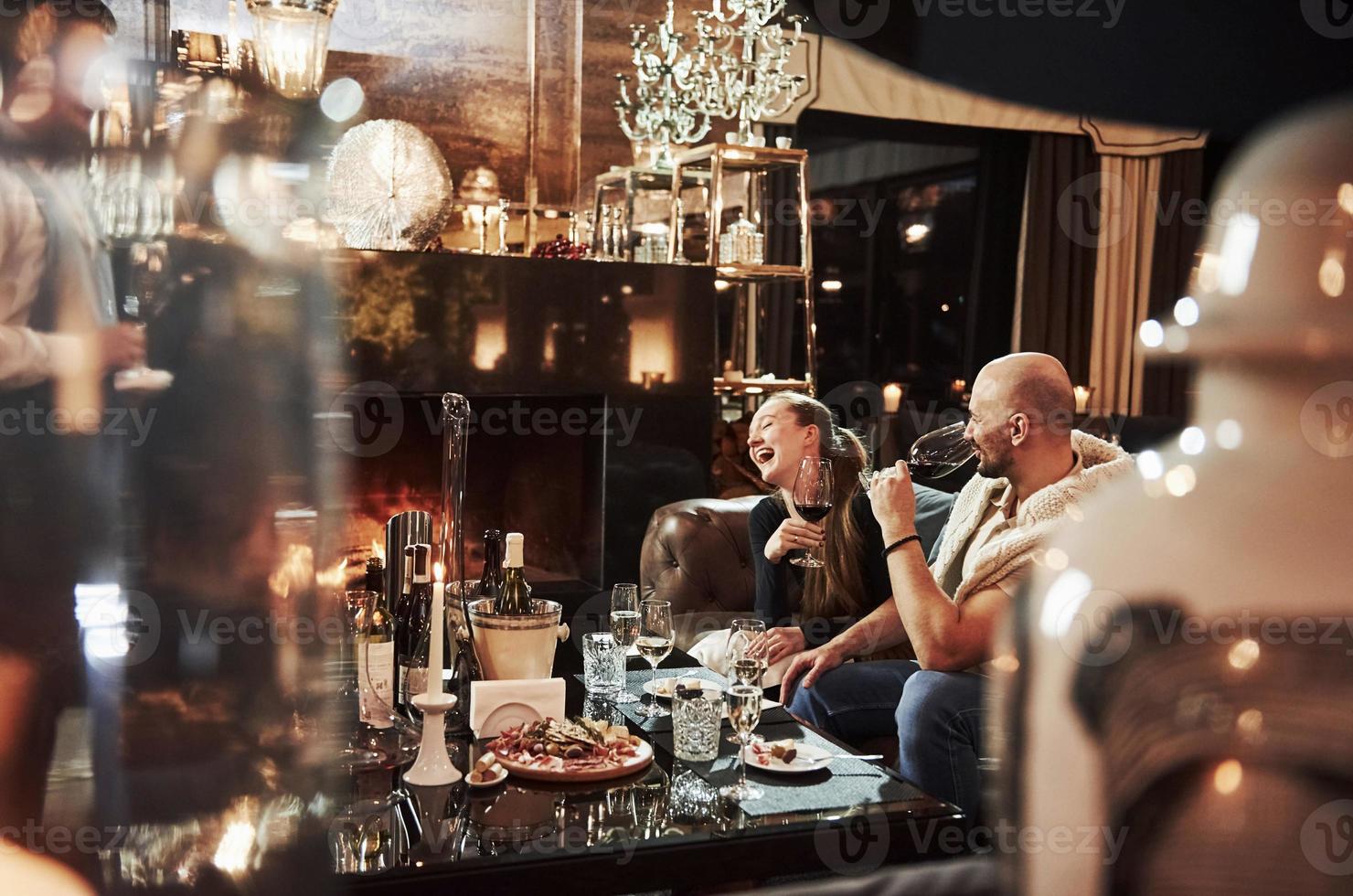 Loud laughing. Girl with her boyfriend have nice evening at beautiful restaurant photo